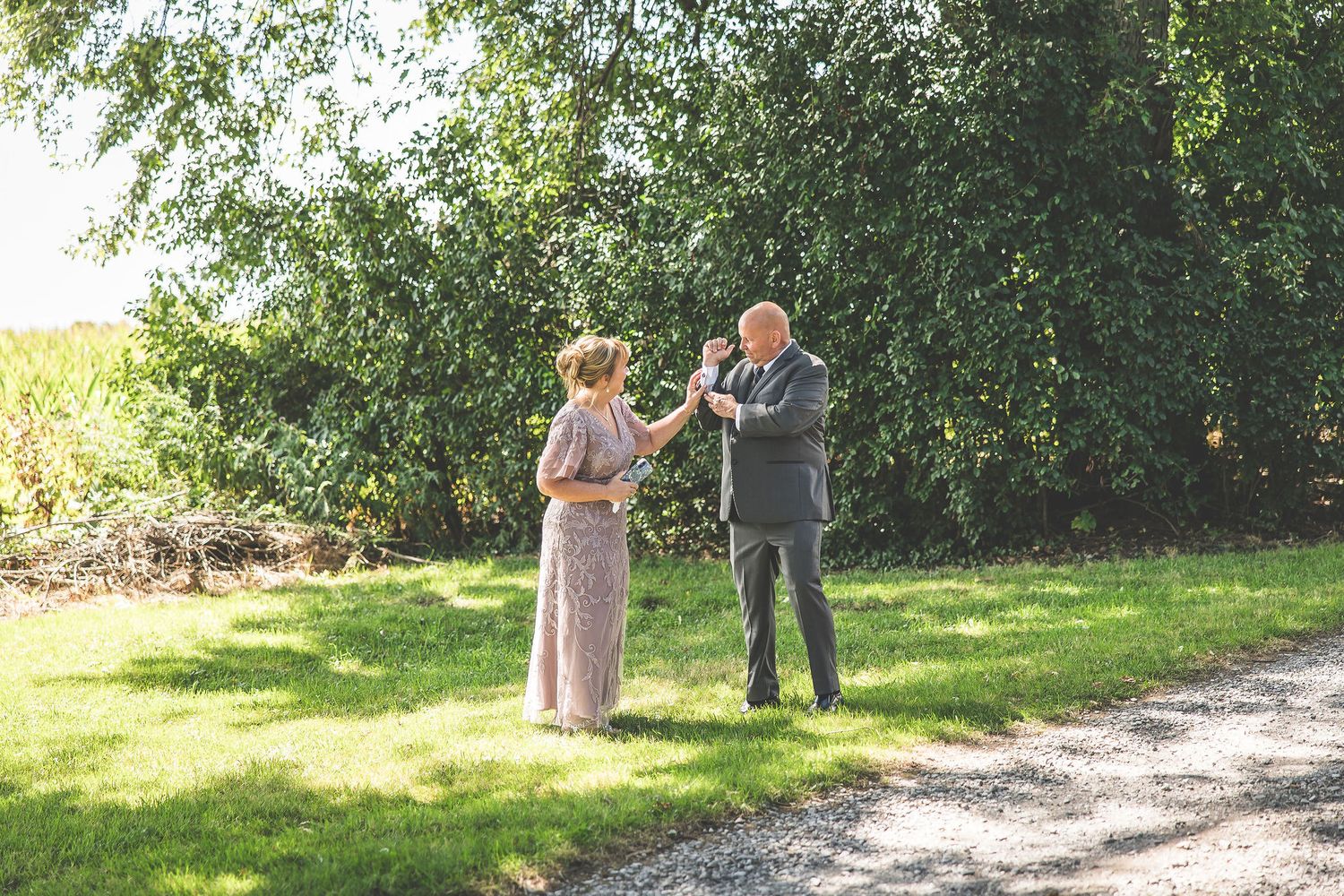 Wedding party members share emotional reactions during an outdoor first look.