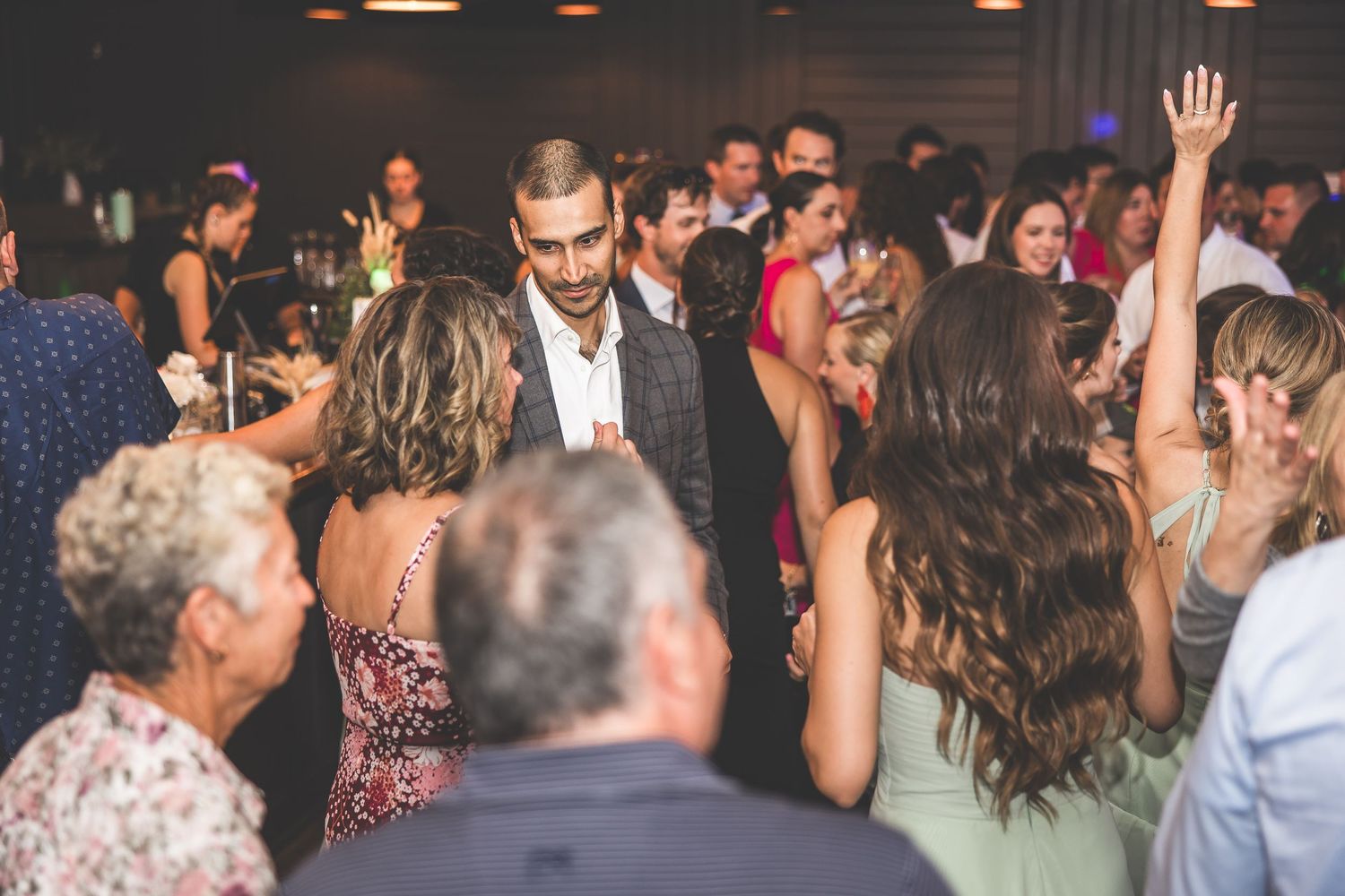 Lively dance floor filled with wedding guests enjoying the celebration.