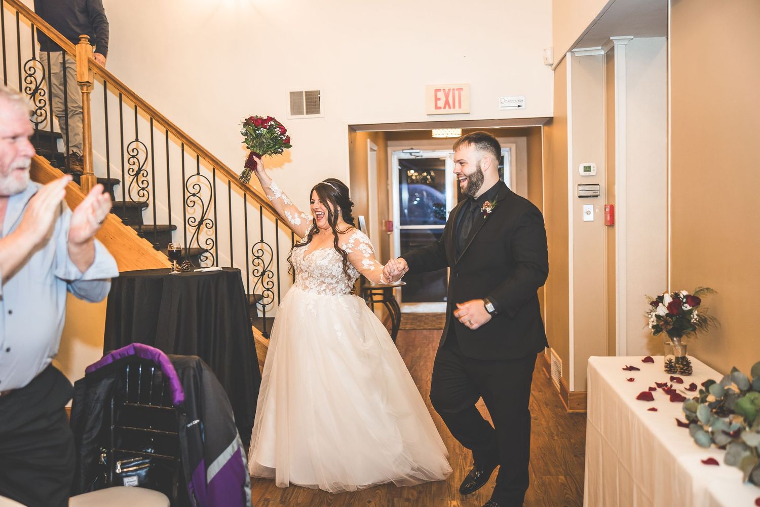 Wedding celebration candid moments captured in an indoor venue with wooden details.