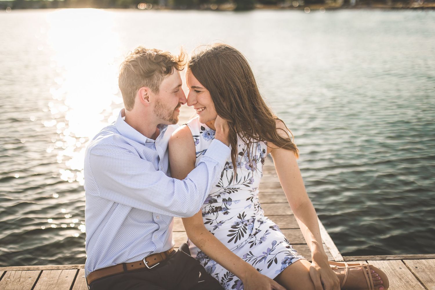 Intimate lakeside moment captured during sunset with water reflections creating a dreamy atmosphere.