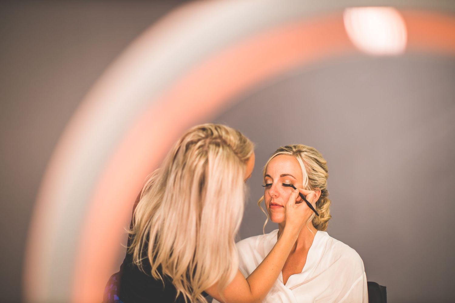 A behind-the-scenes moment of wedding day makeup preparation.