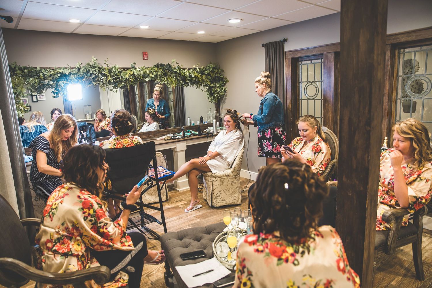 Wedding ceremony guests seated in rows watching an indoor celebration.
