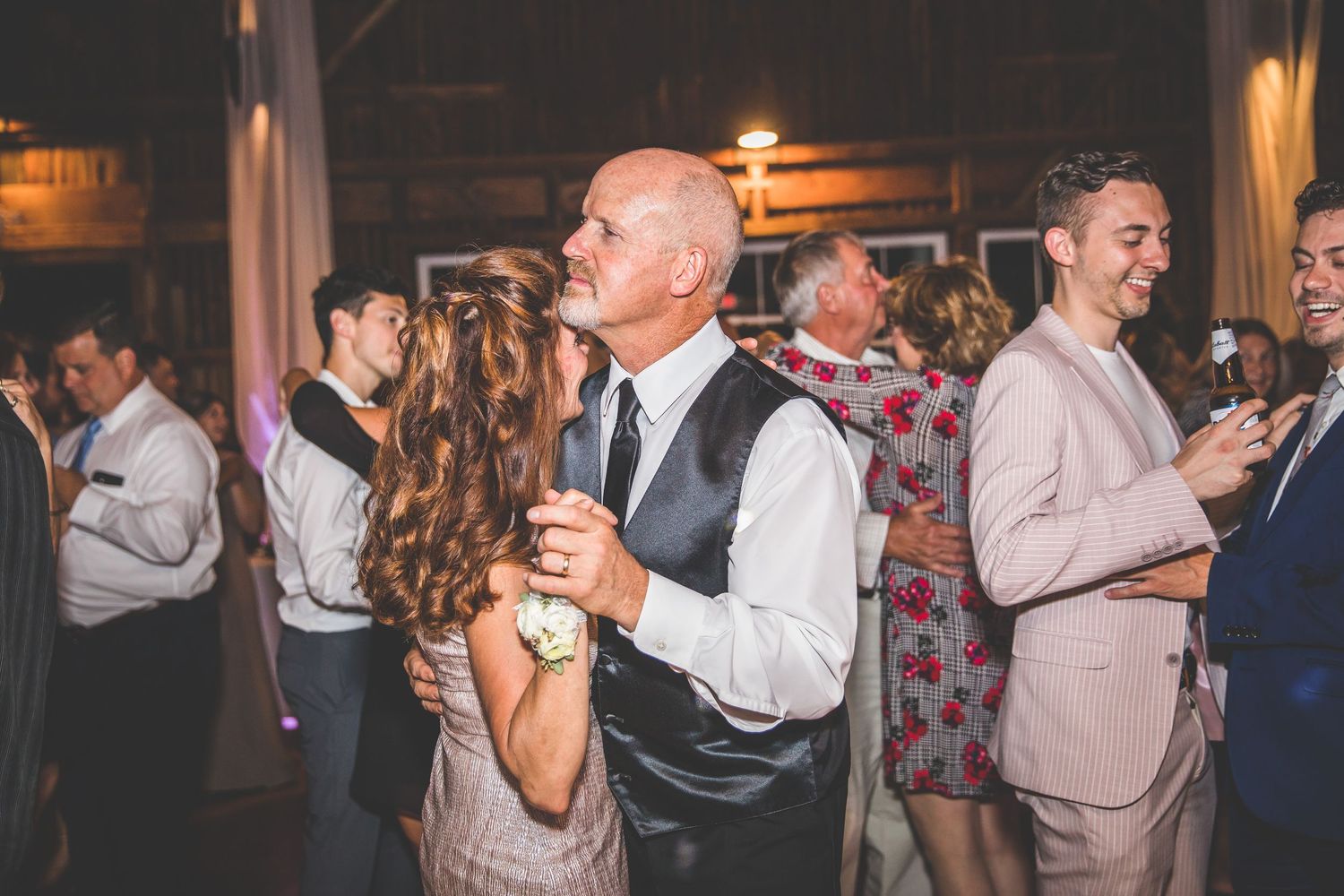 Wedding guests dancing and enjoying themselves at an evening reception.