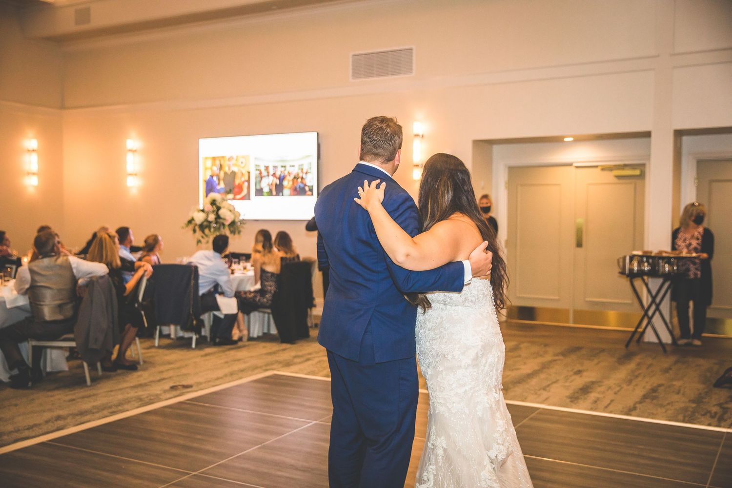 Wedding reception dance floor with guests enjoying the celebration in an elegant venue.