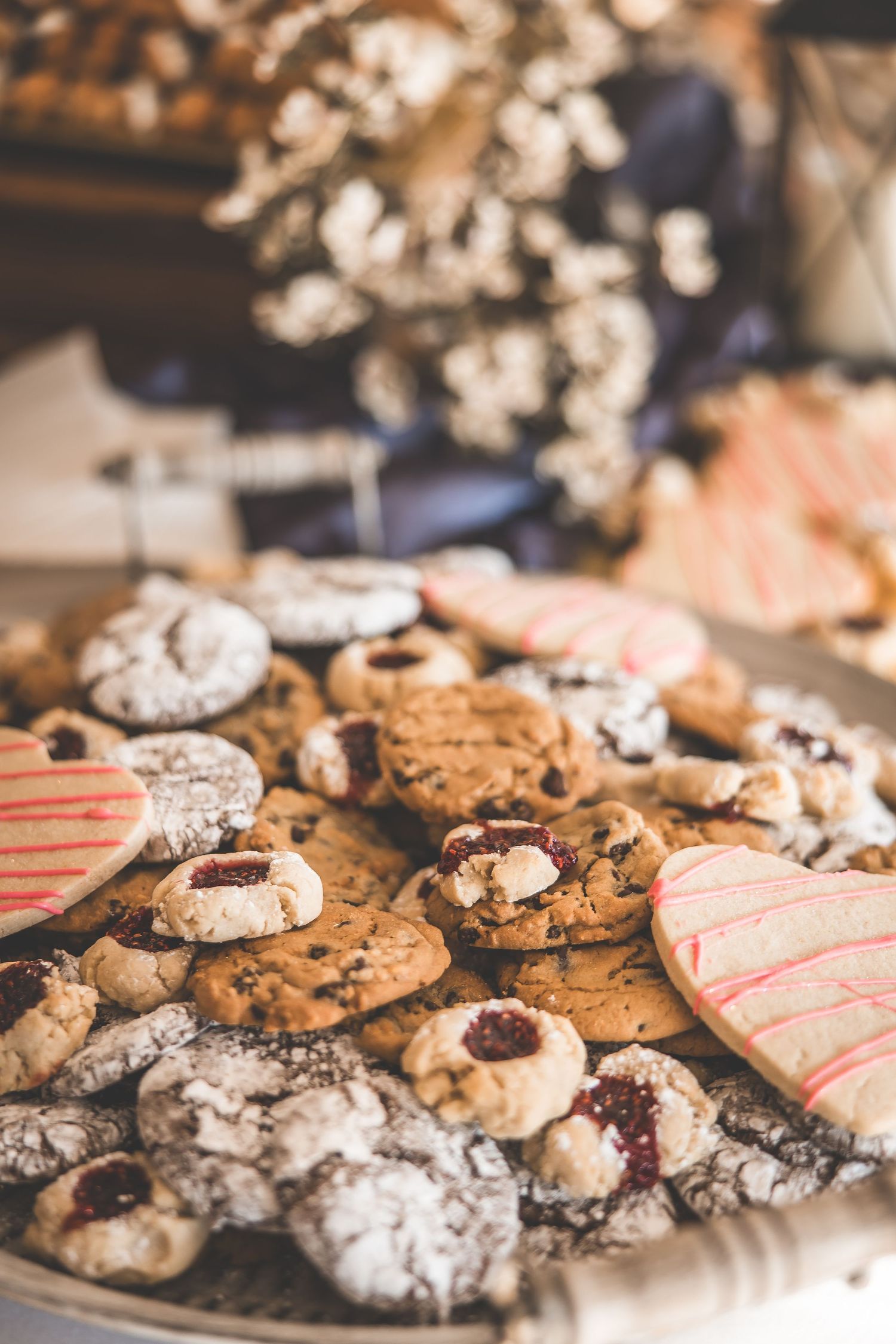 Assorted wedding cookies and desserts displayed on rustic platters.