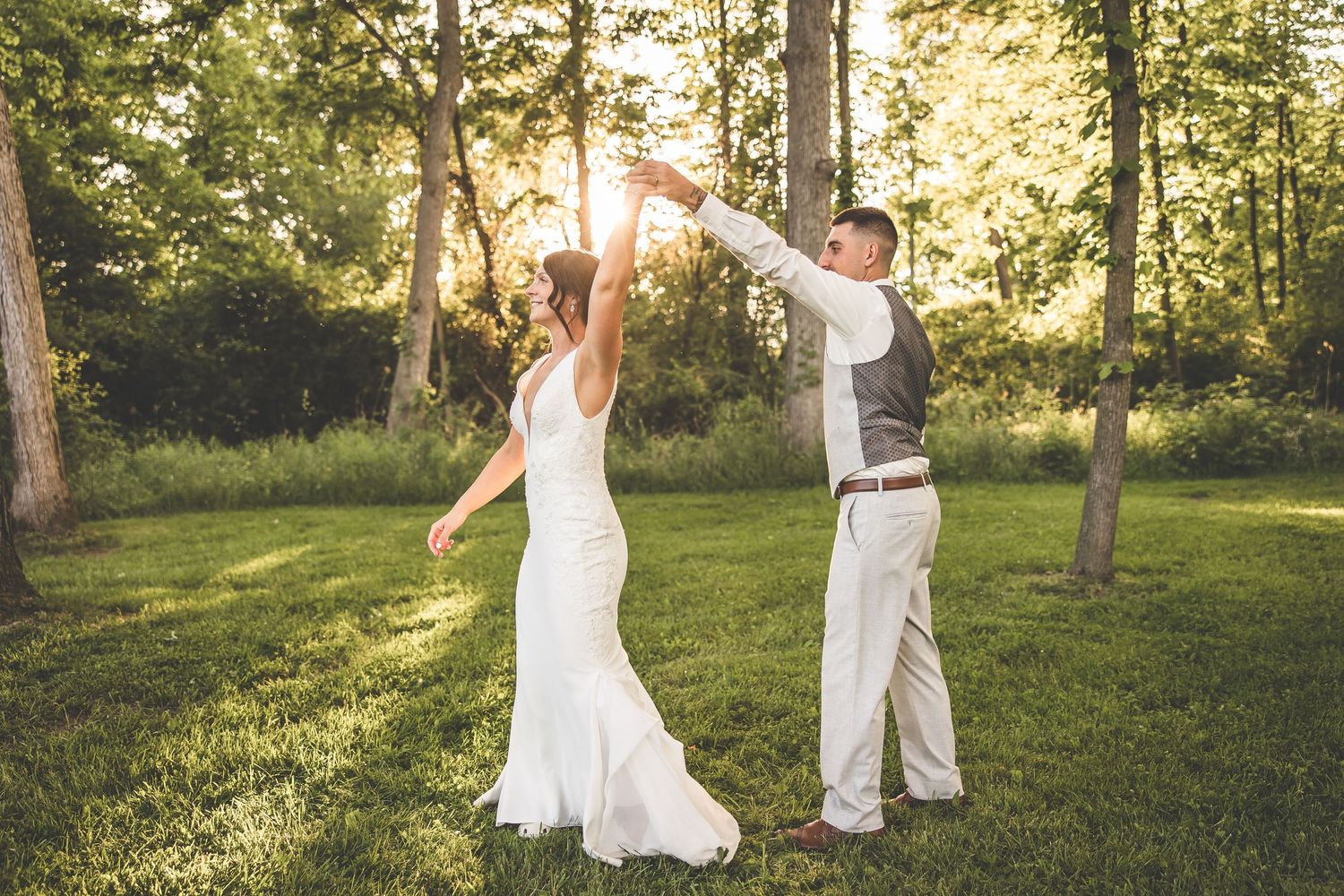 Dancing together in a sunlit forest clearing during golden hour.