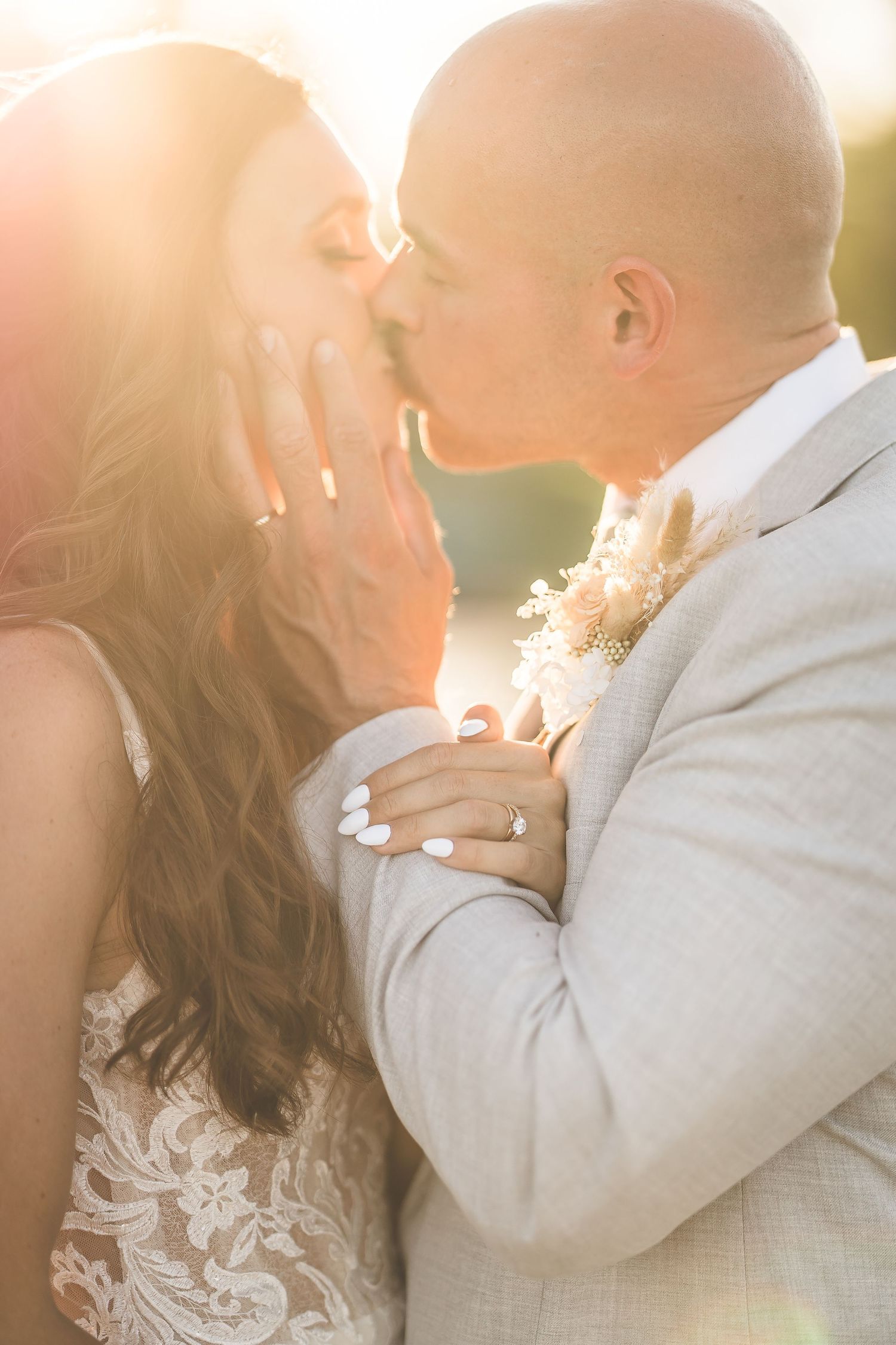 Romantic close-up wedding portraits bathed in warm sunset light.