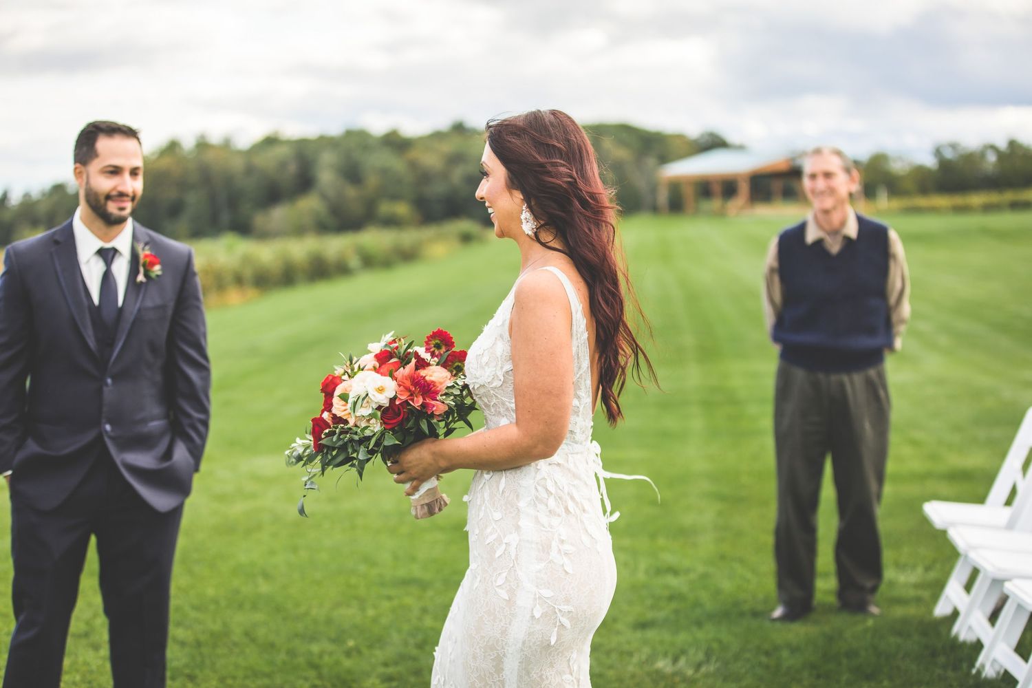 Outdoor wedding ceremony scene with elegant decor and natural landscape backdrop.