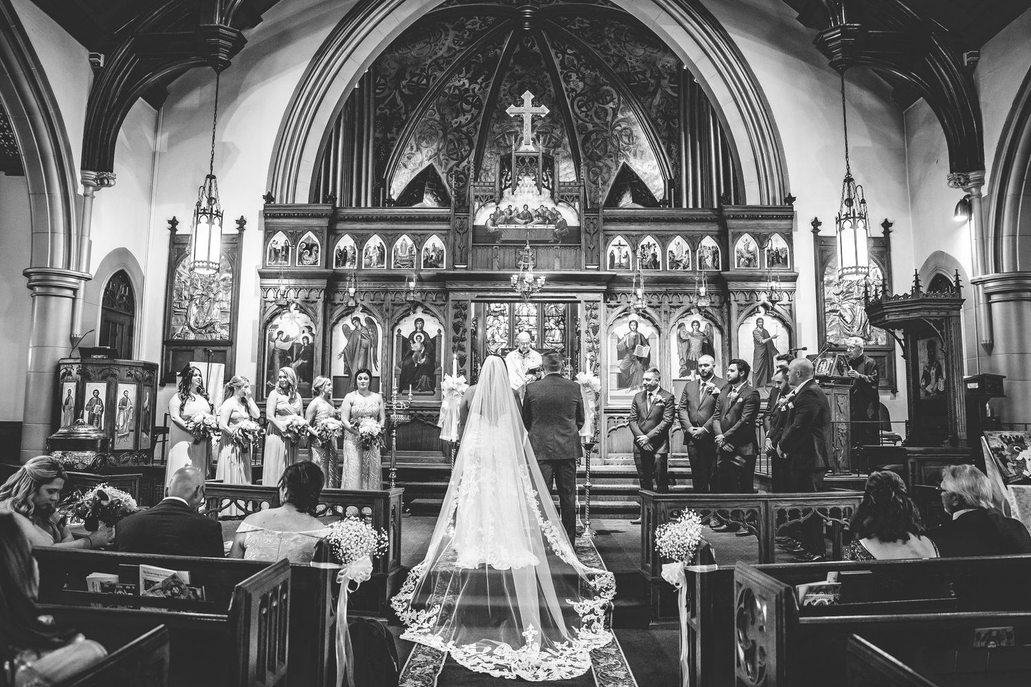 Black and white panoramic view of traditional church wedding ceremony.