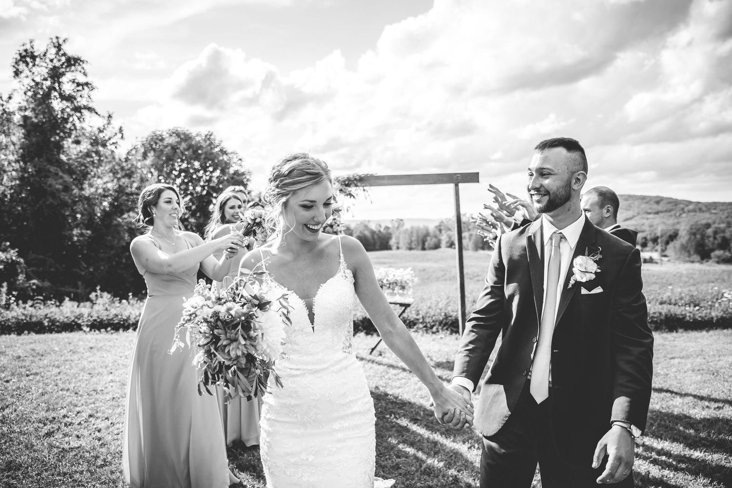 A candid black and white wedding photo sequence showing joyful moments in an outdoor setting.