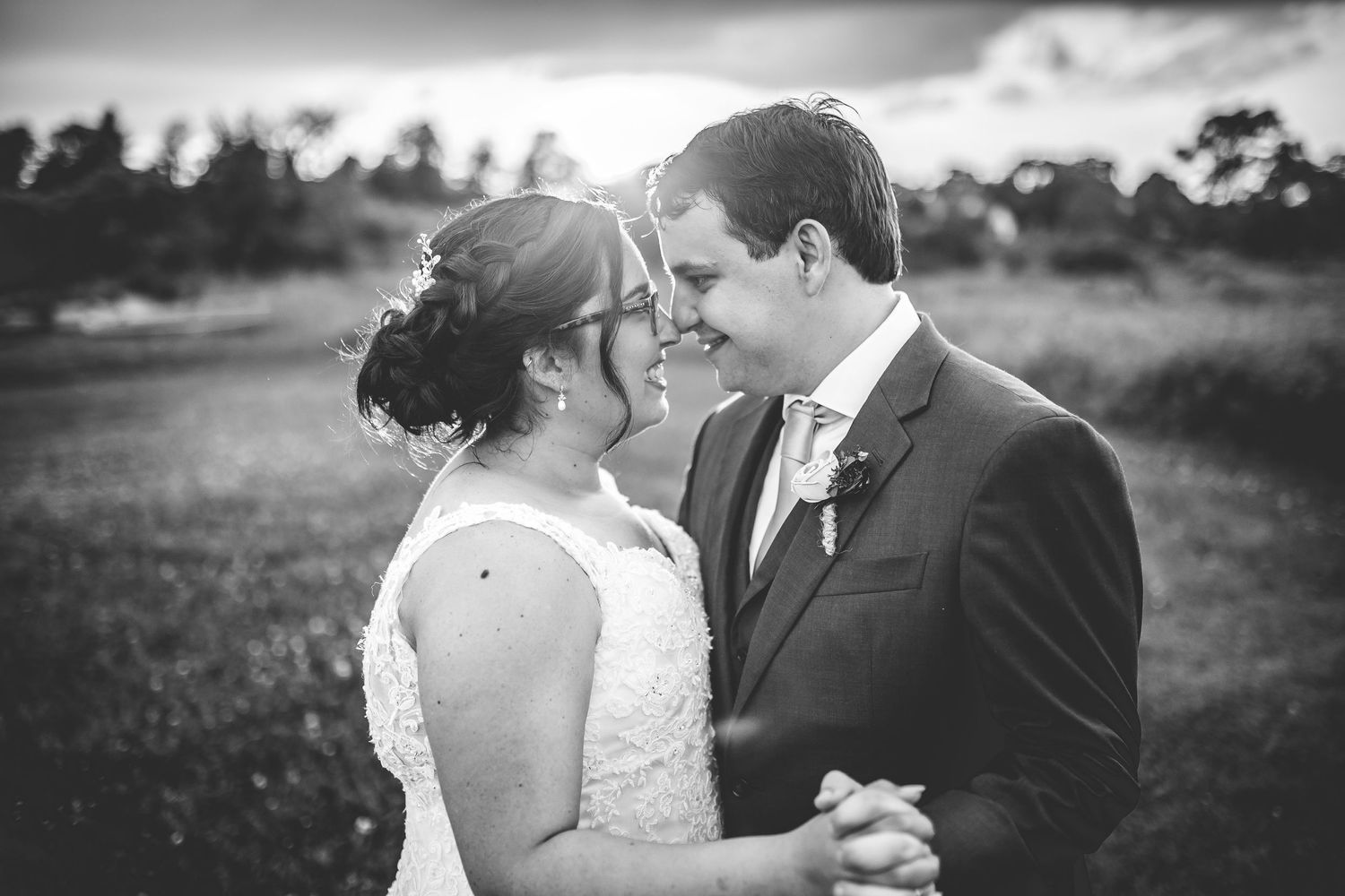 Black and white romantic wedding portraits in a natural outdoor setting.