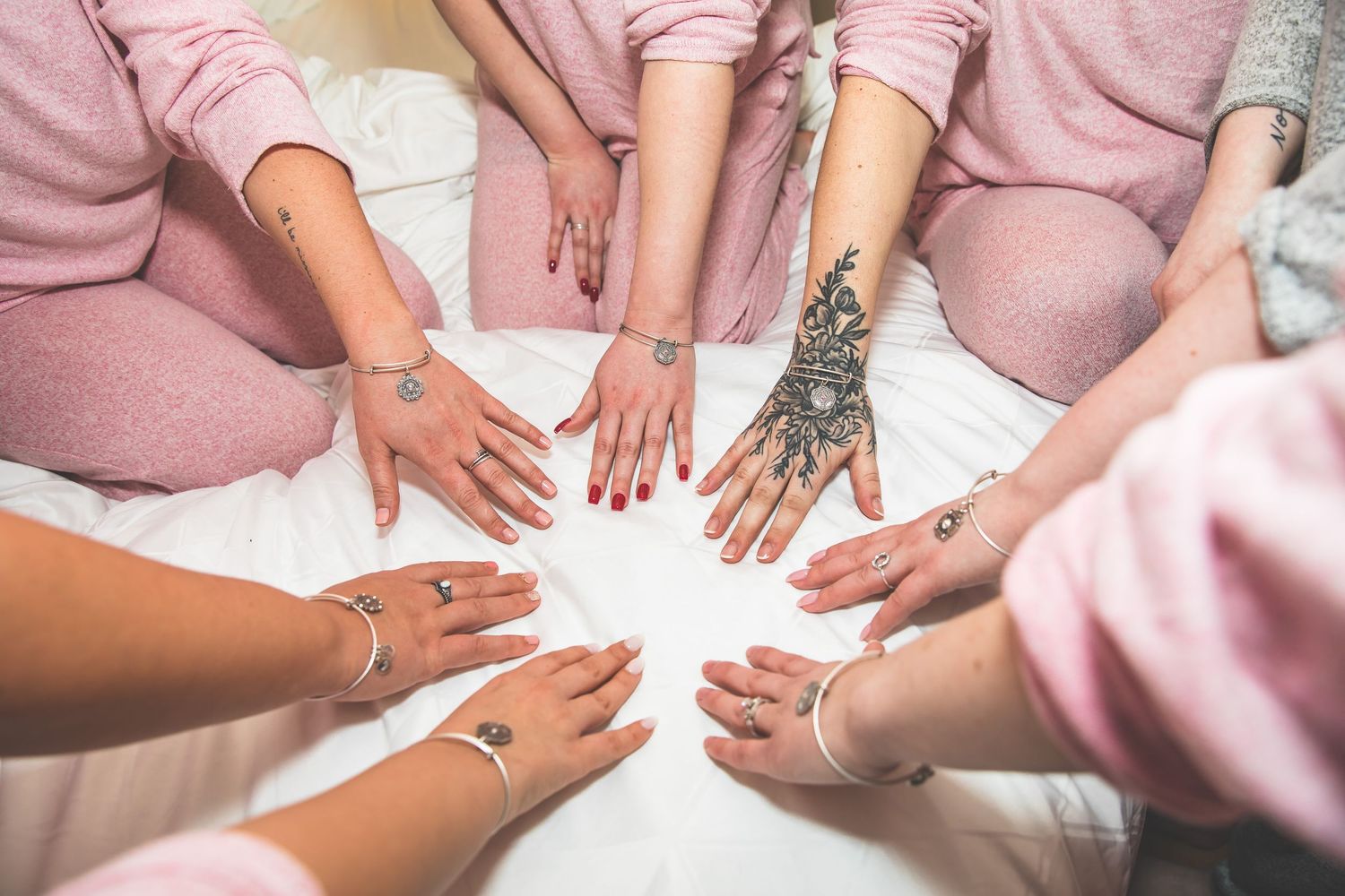 Hands placed together in a circle showing unity and friendship.
