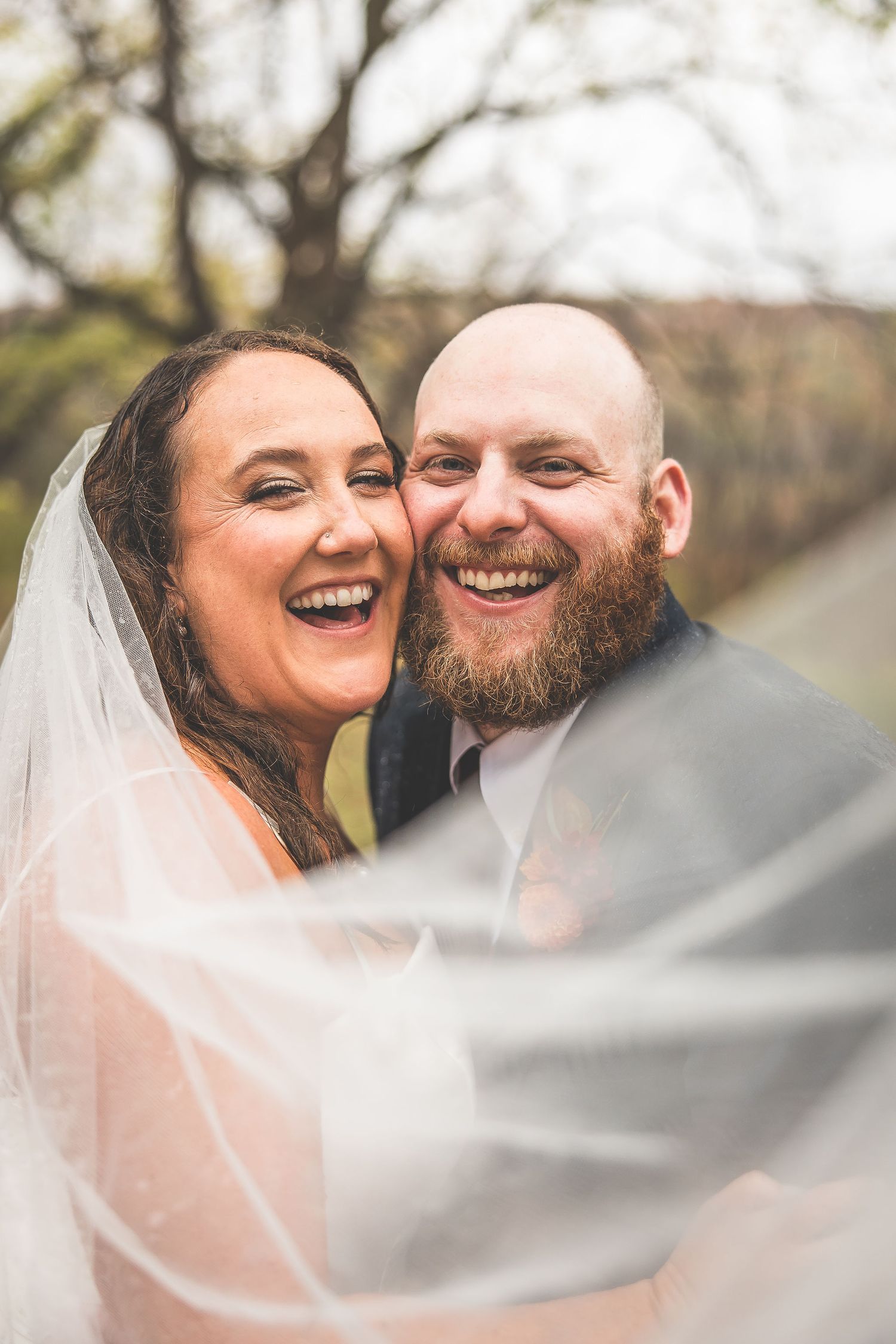 A candid moment of pure joy and laughter shared between newlyweds.