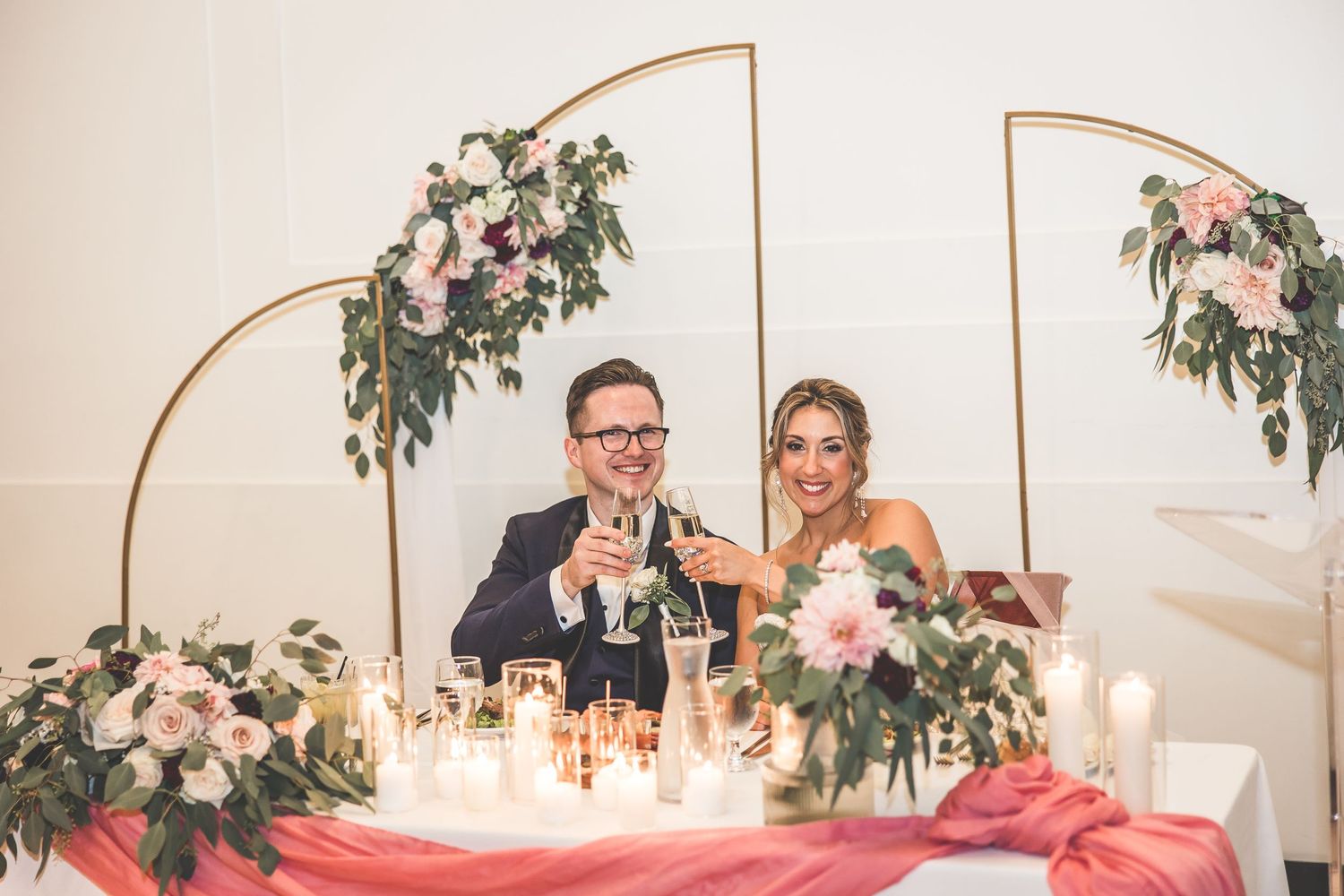 Wedding reception venue decorated with elegant floral arrangements and candlelit tables for an intimate celebration.