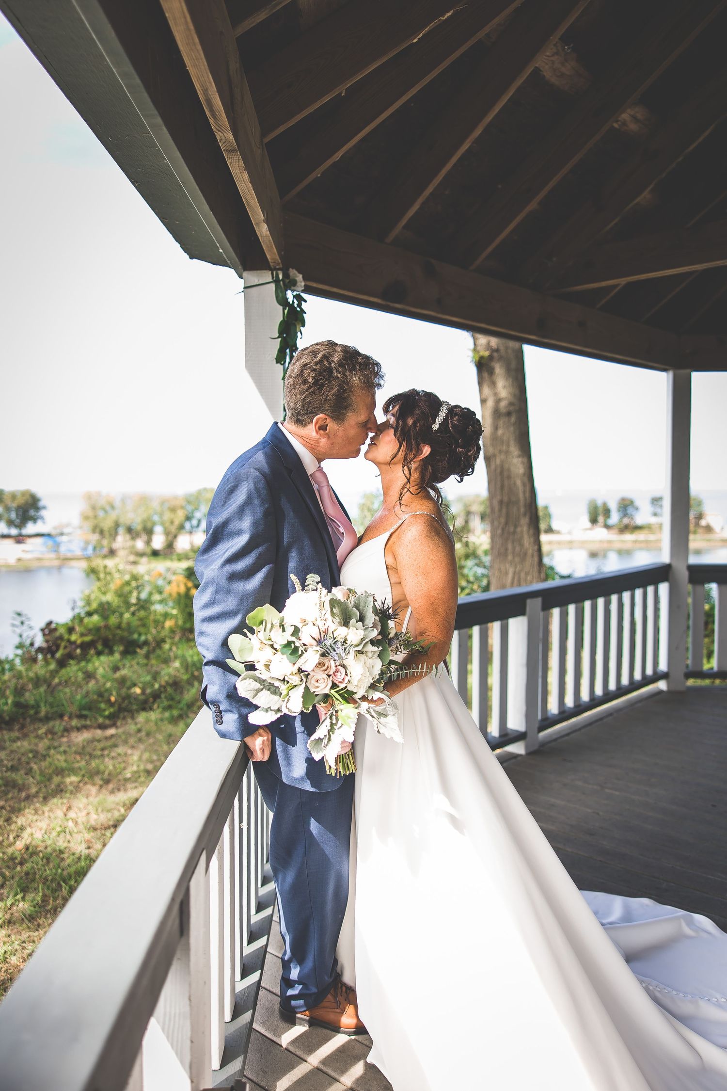 Series of intimate first look moments between couple on covered deck with natural light.