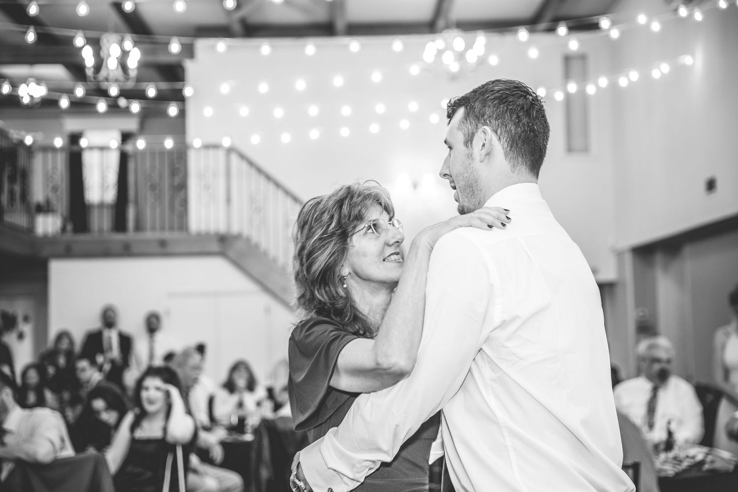 Wedding reception dance floor with string lights overhead.