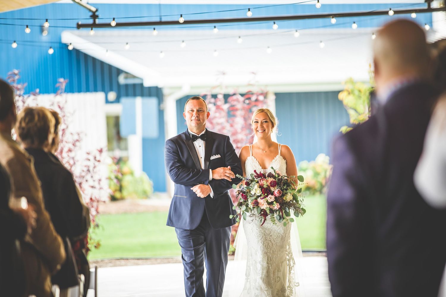 Modern wedding reception venue with blue accent lighting and white decor.