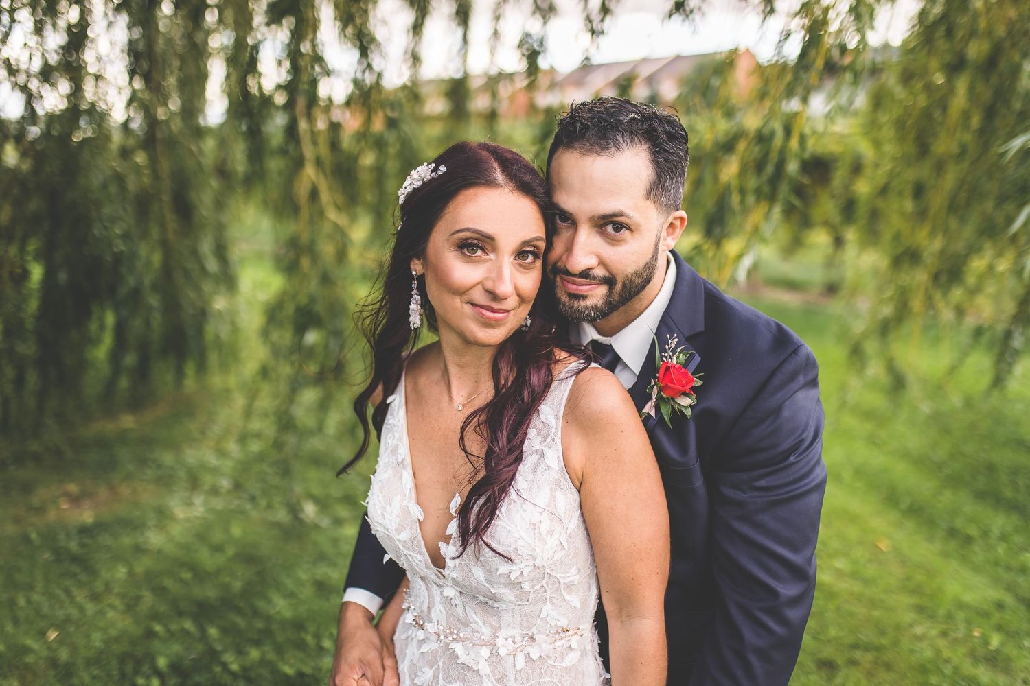 Wedding couple shares intimate moments in an outdoor garden setting.
