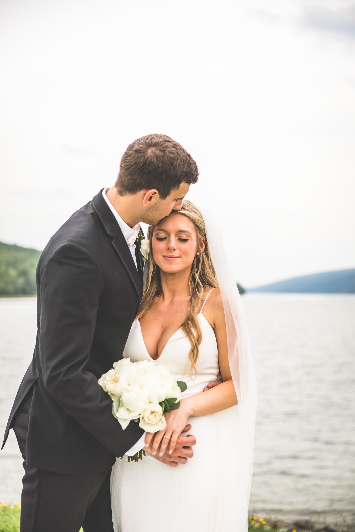 Romantic wedding couple moments captured by the waterfront.