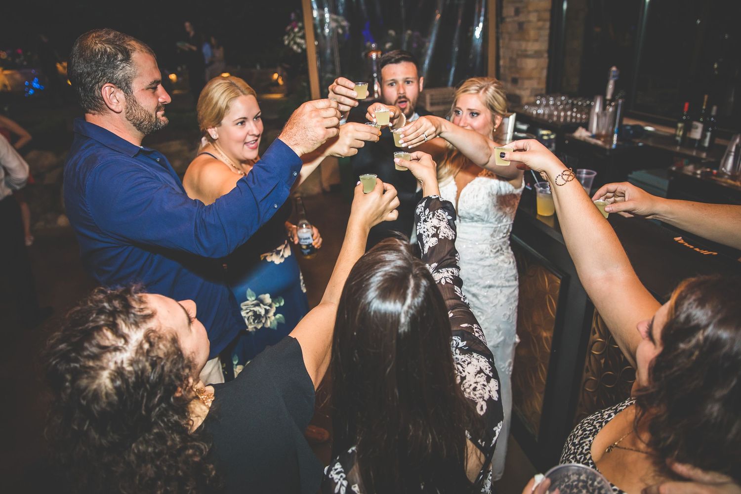Wedding guests raise their glasses in a celebratory toast during the reception.