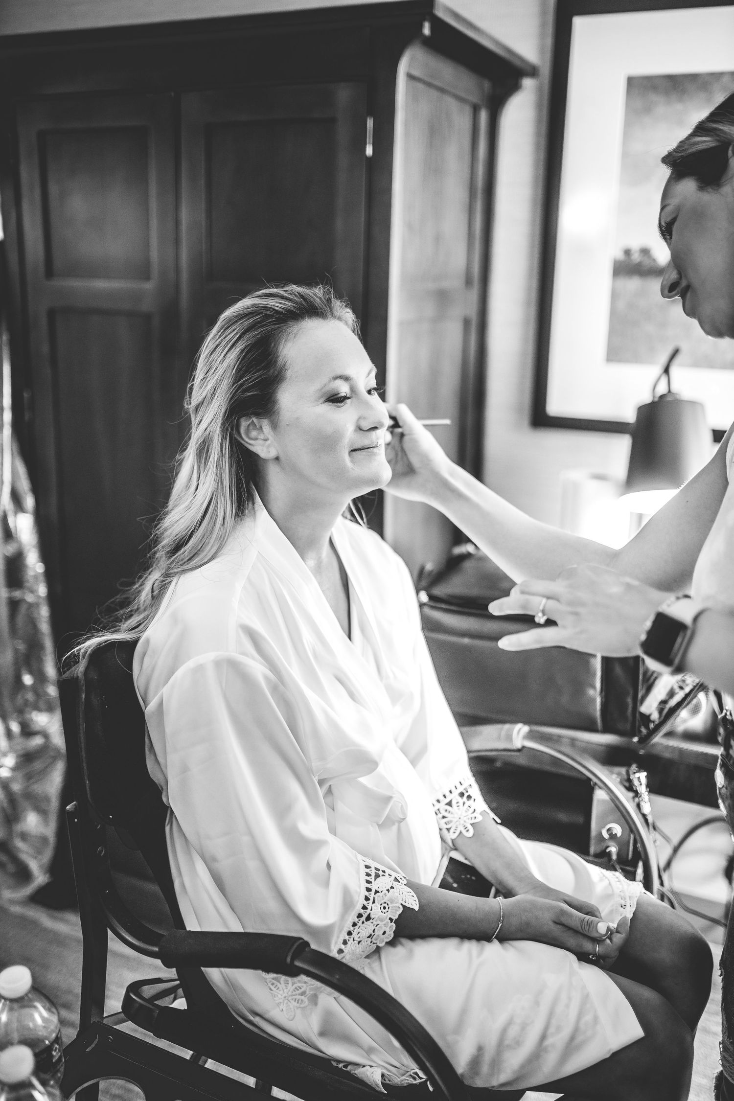 Black and white photos of wedding morning preparations showing makeup application.