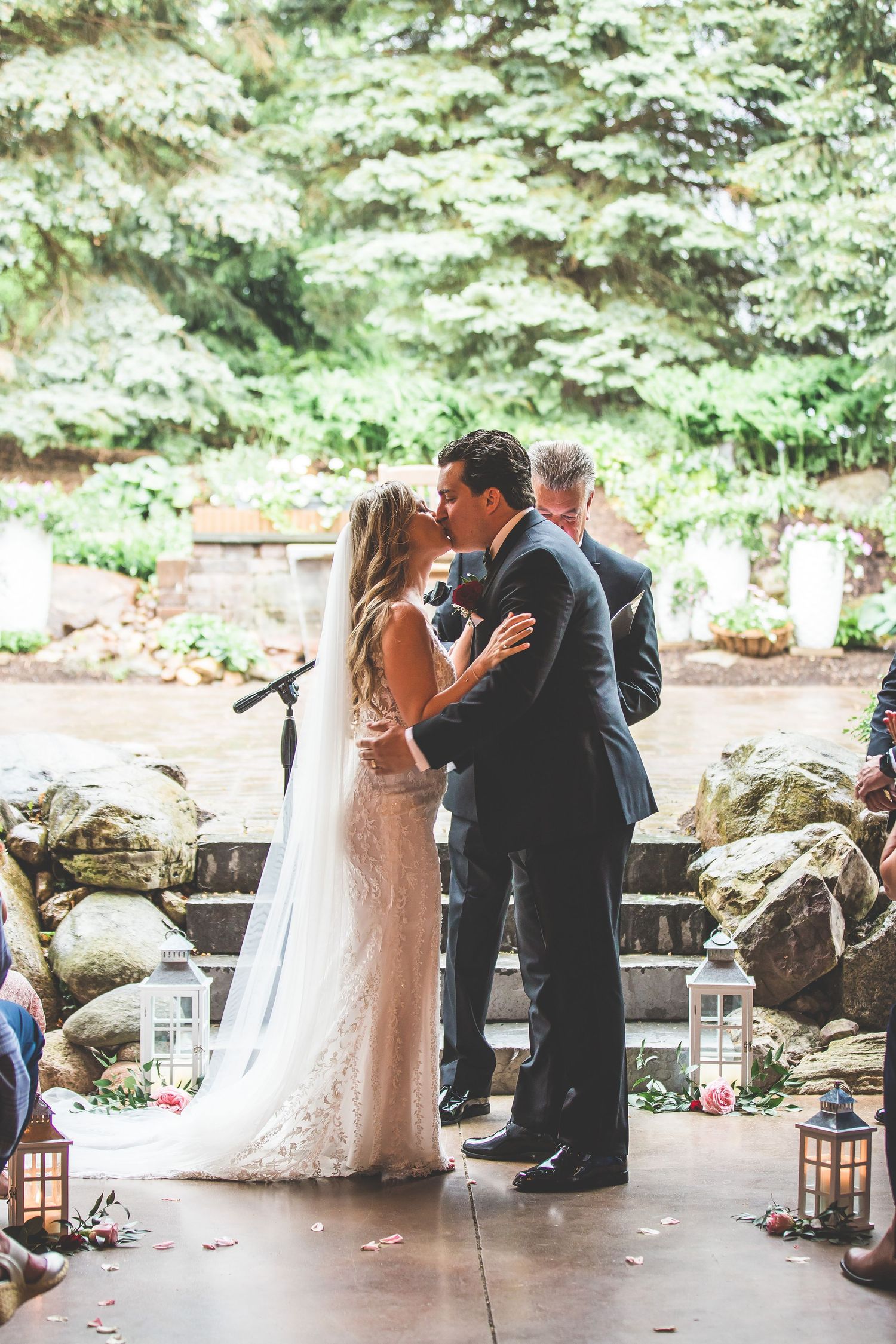 Wedding ceremony moments captured under a rustic covered patio with stone details.