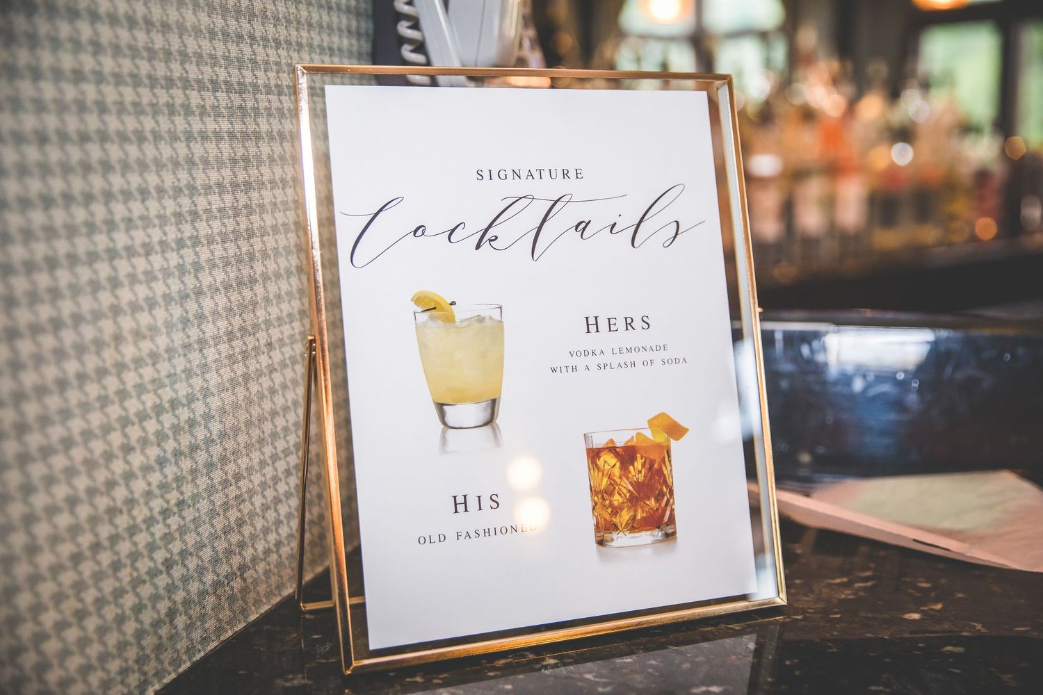 Wedding reception signage and menu cards displayed on rustic wooden surfaces.