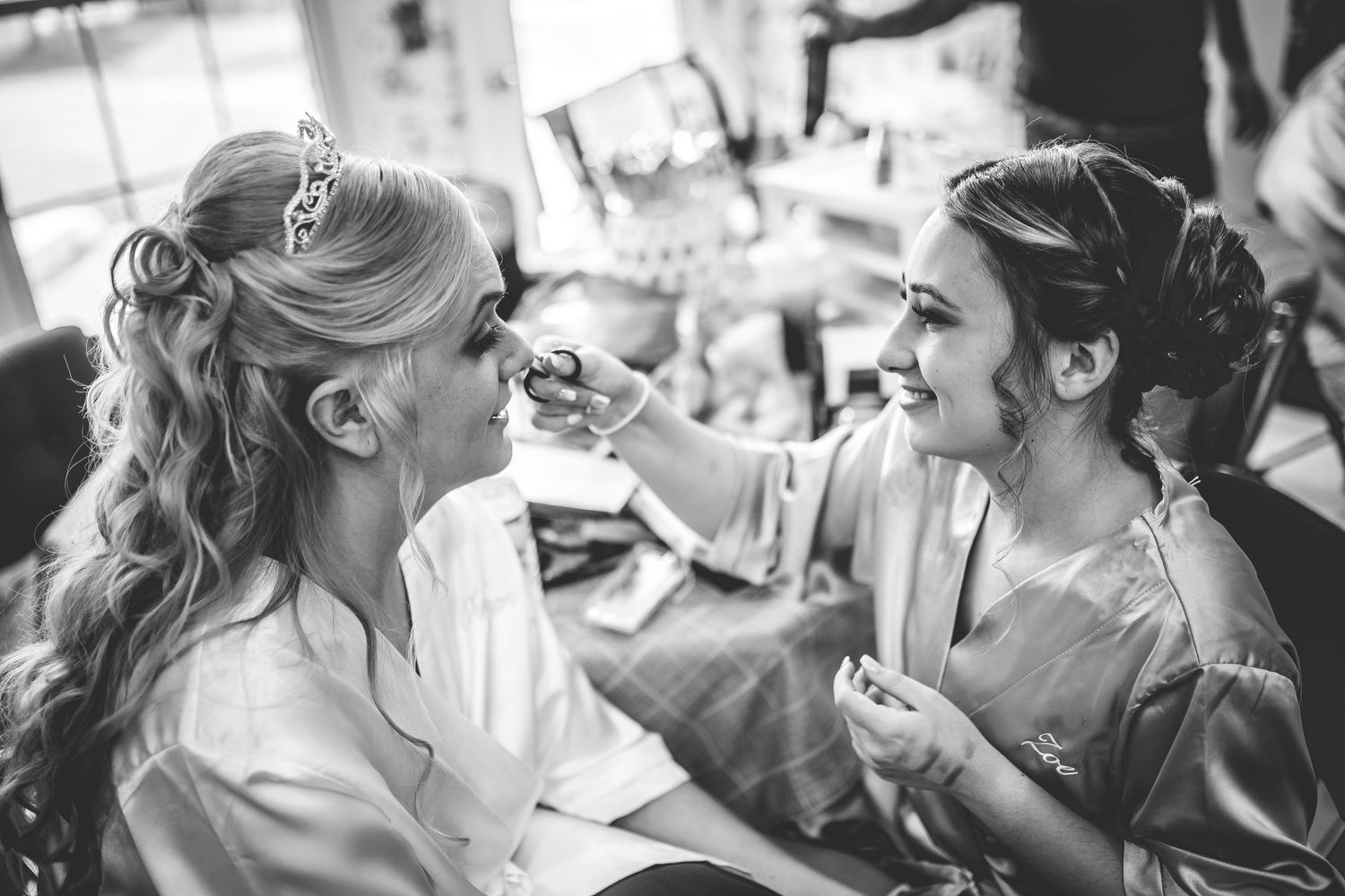Black and white photo of bridal party getting ready before the ceremony.