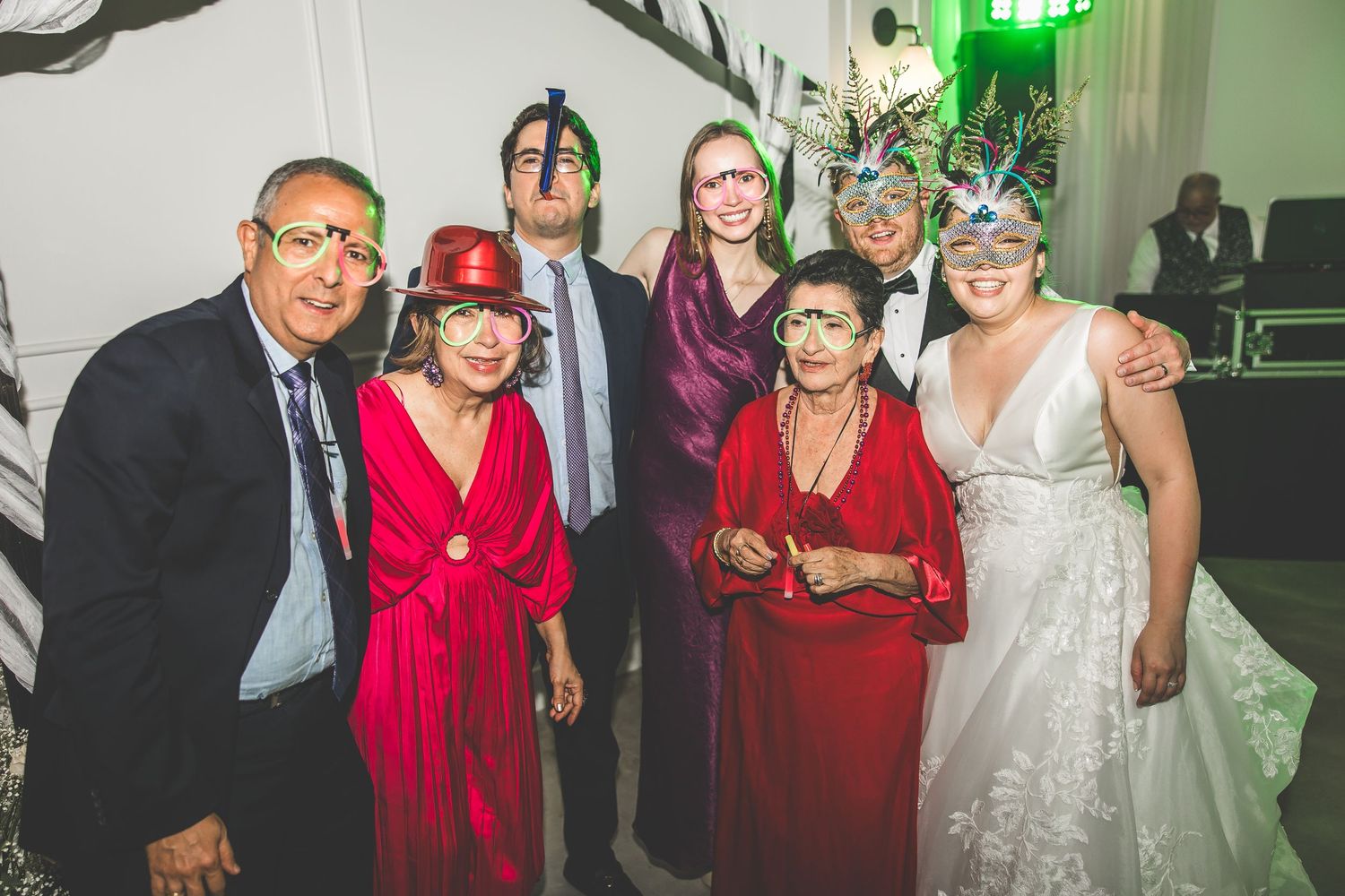 Wedding reception guests in formal attire dancing and celebrating together.