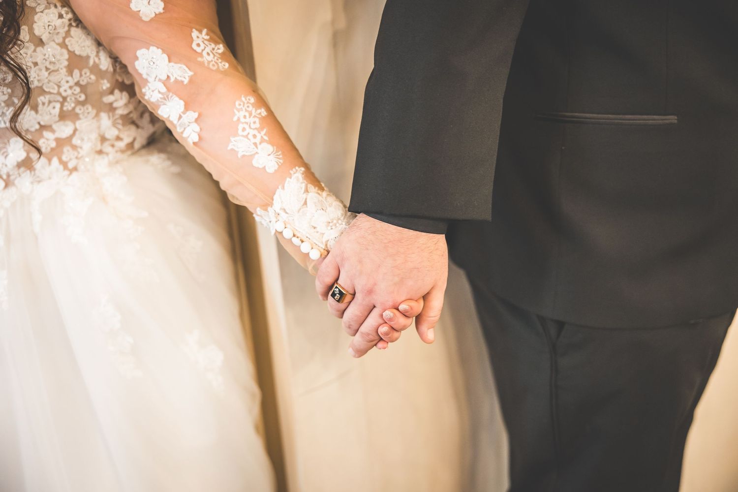 Close-up details of lace wedding dress and formal attire.