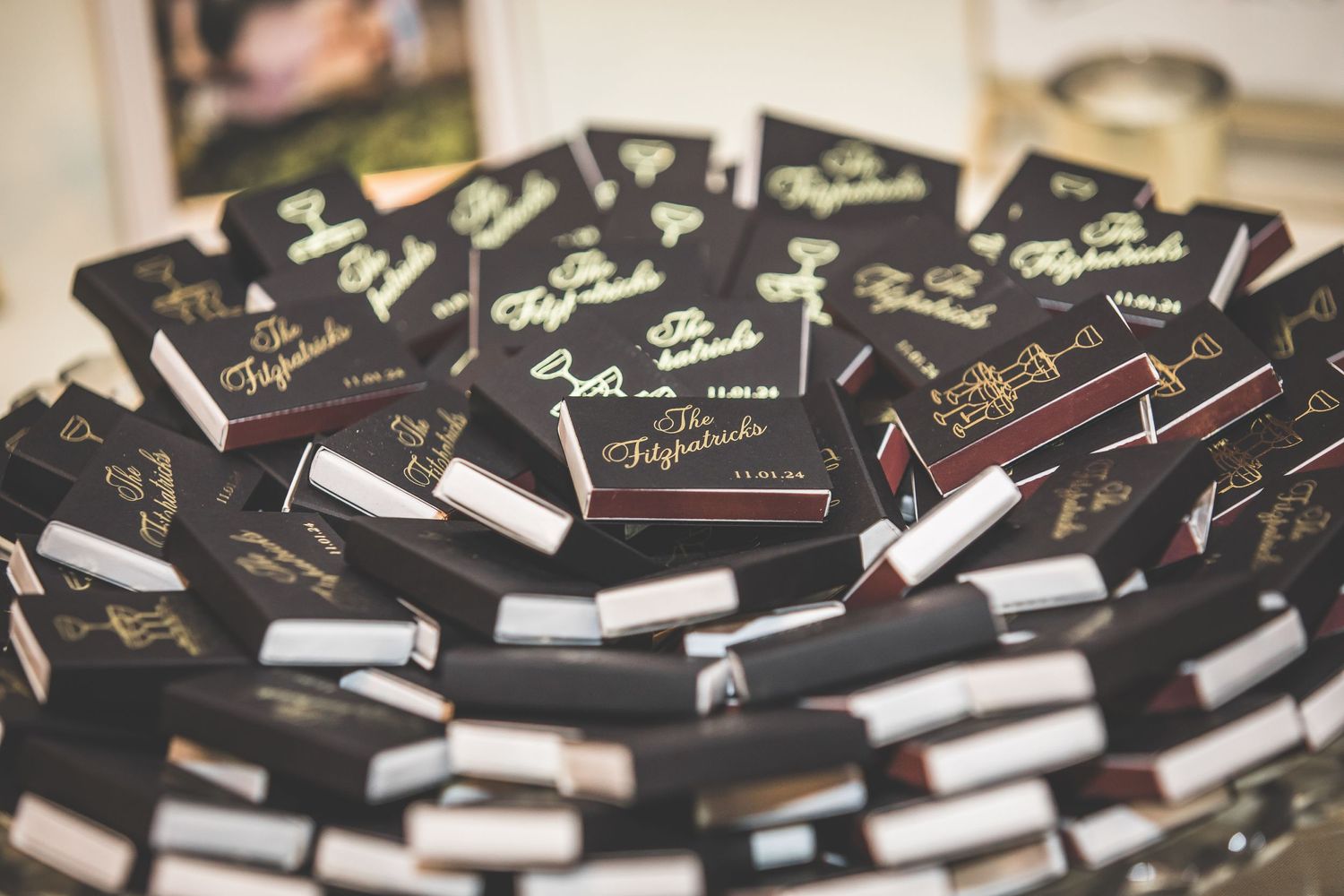 Collection of black wedding favor boxes arranged with white ribbons.