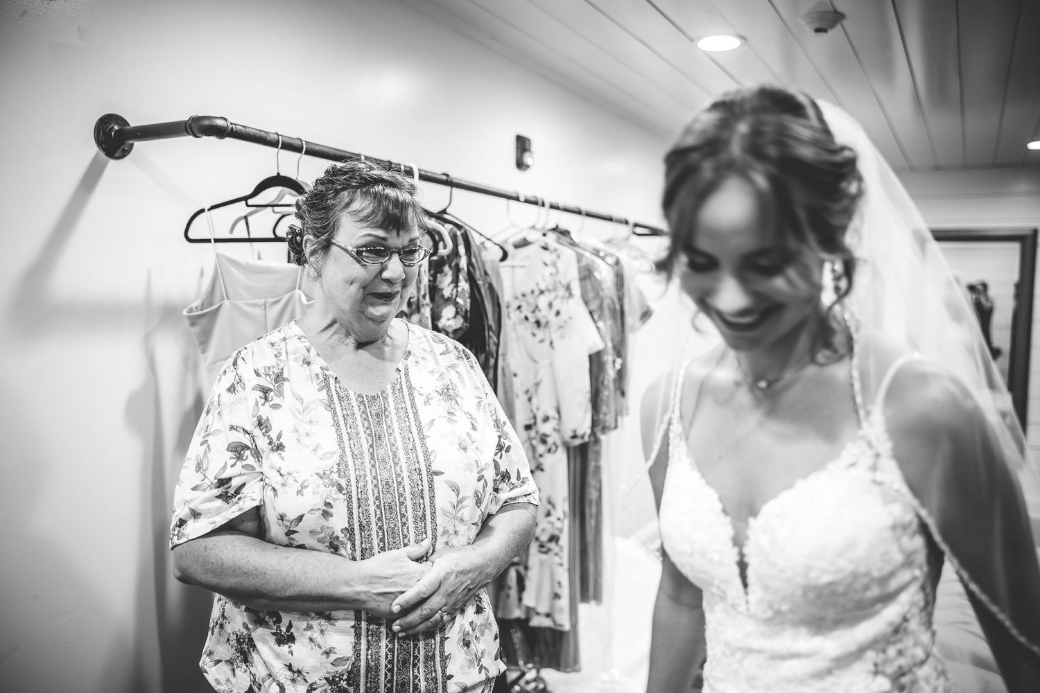 Behind the scenes shot of wedding dress preparations with hangers visible.
