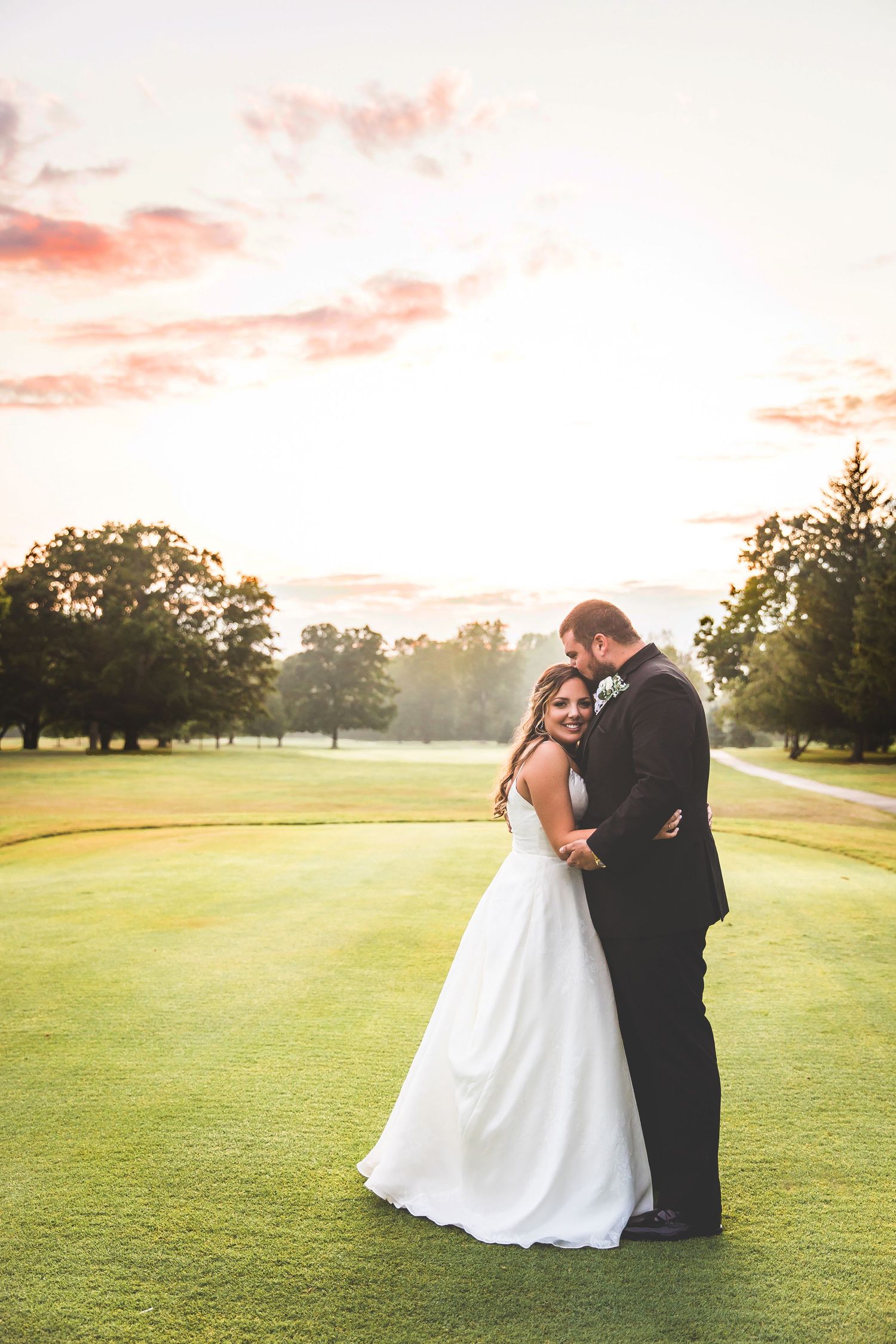 Romantic sunset portraits on a golf course with warm golden light.