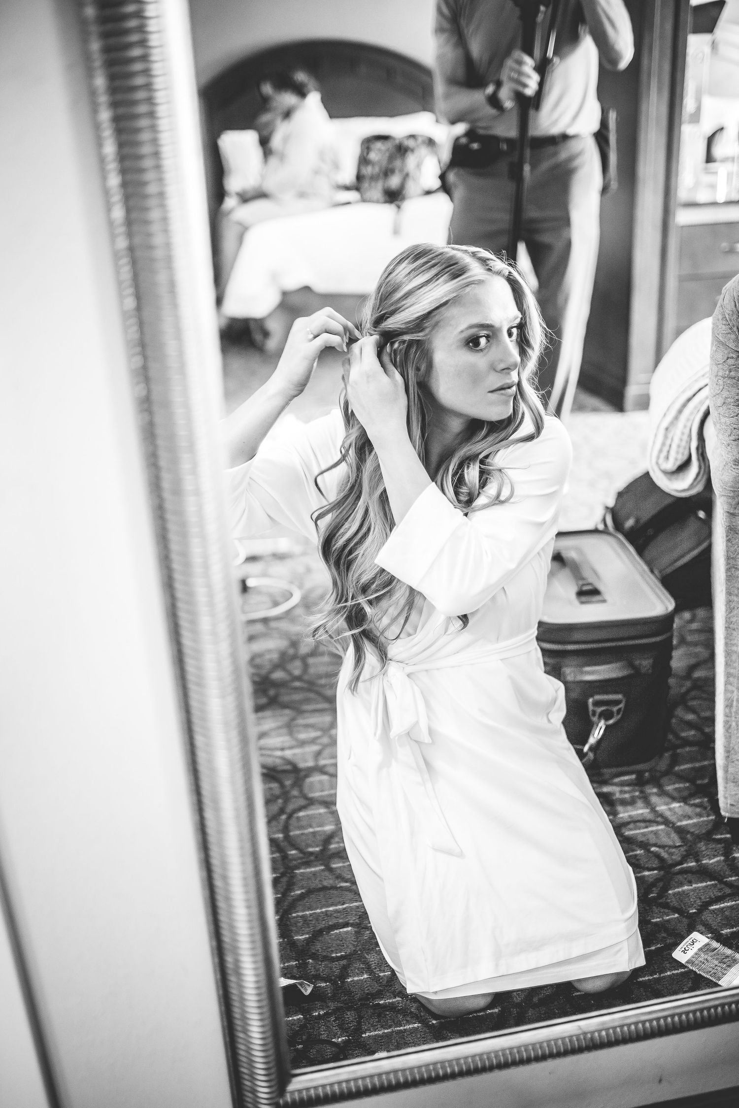 Getting ready candid moments before a wedding ceremony in a hotel room.