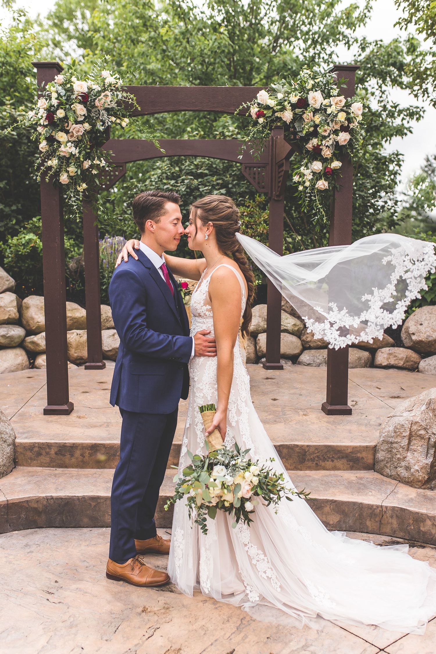 A romantic wedding photo sequence showing a couple posing outdoors with a flowing veil against a rustic wooden pergola.