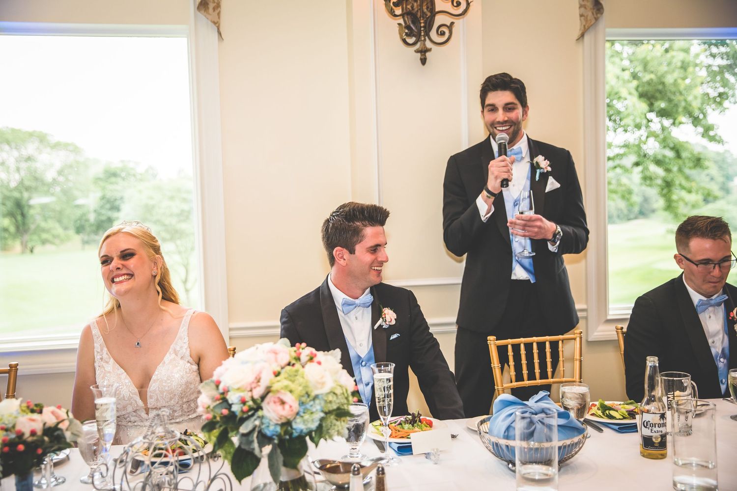 Wedding reception scene with elegant table settings and formal dining decor.