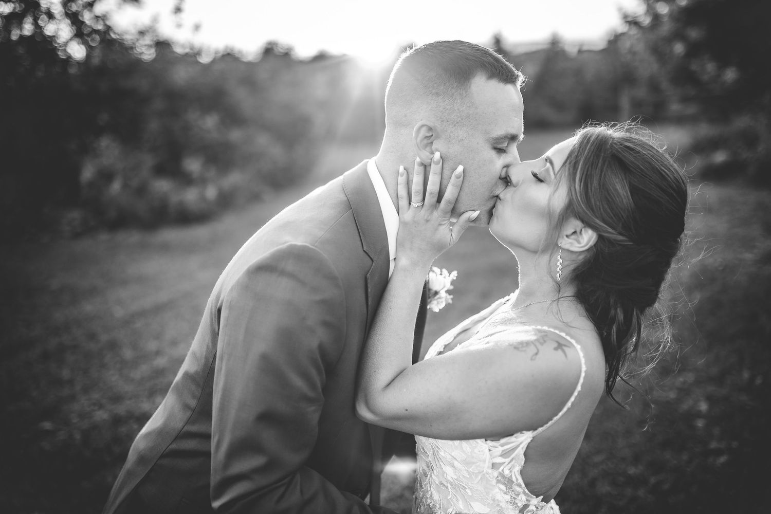 Black and white wedding photos capture intimate moments between newlyweds at sunset.