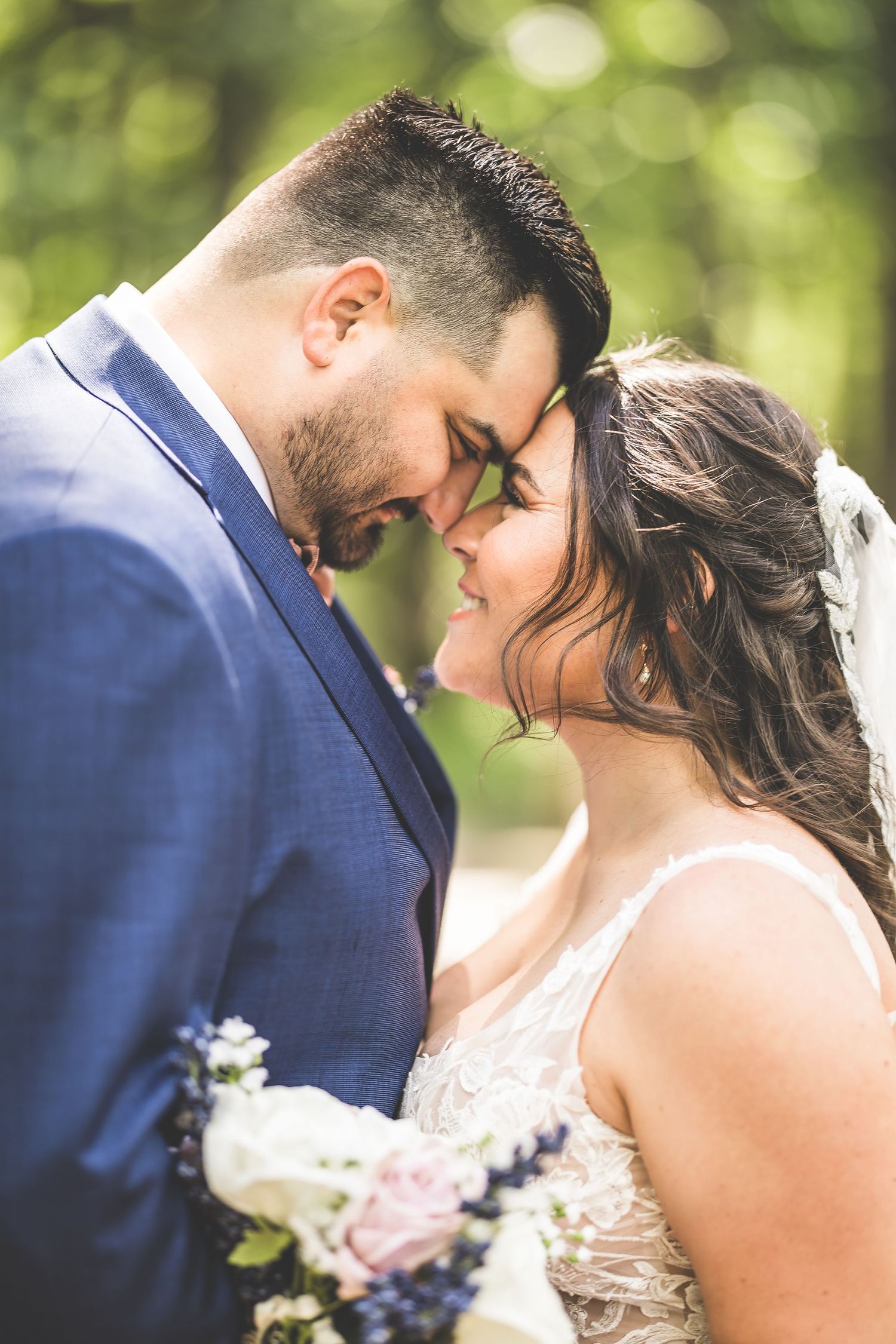 Close-up wedding portraits showing tender moments between newlyweds in a natural outdoor setting.