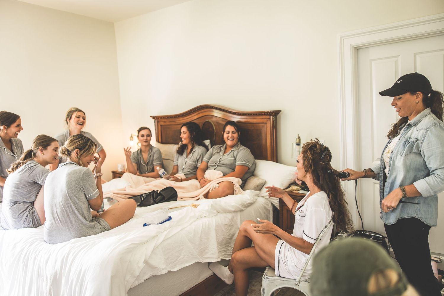 Wedding party members relaxing together in casual attire before the ceremony.