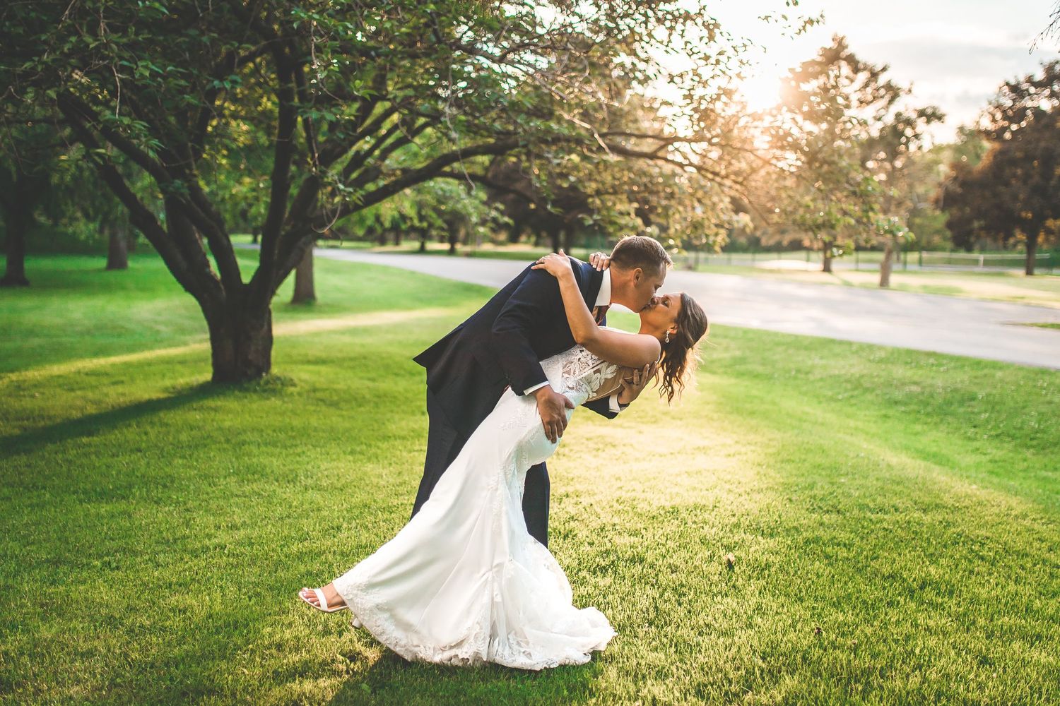 Romantic sunset wedding photos captured on a lush green golf course.