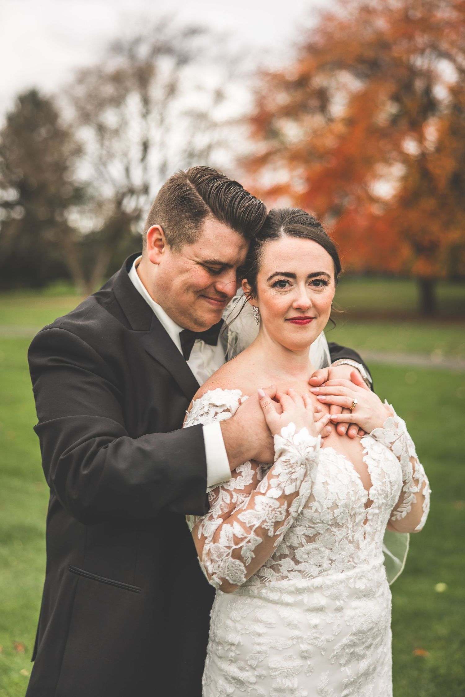 Tender wedding moments captured in a series of romantic poses against autumn trees.