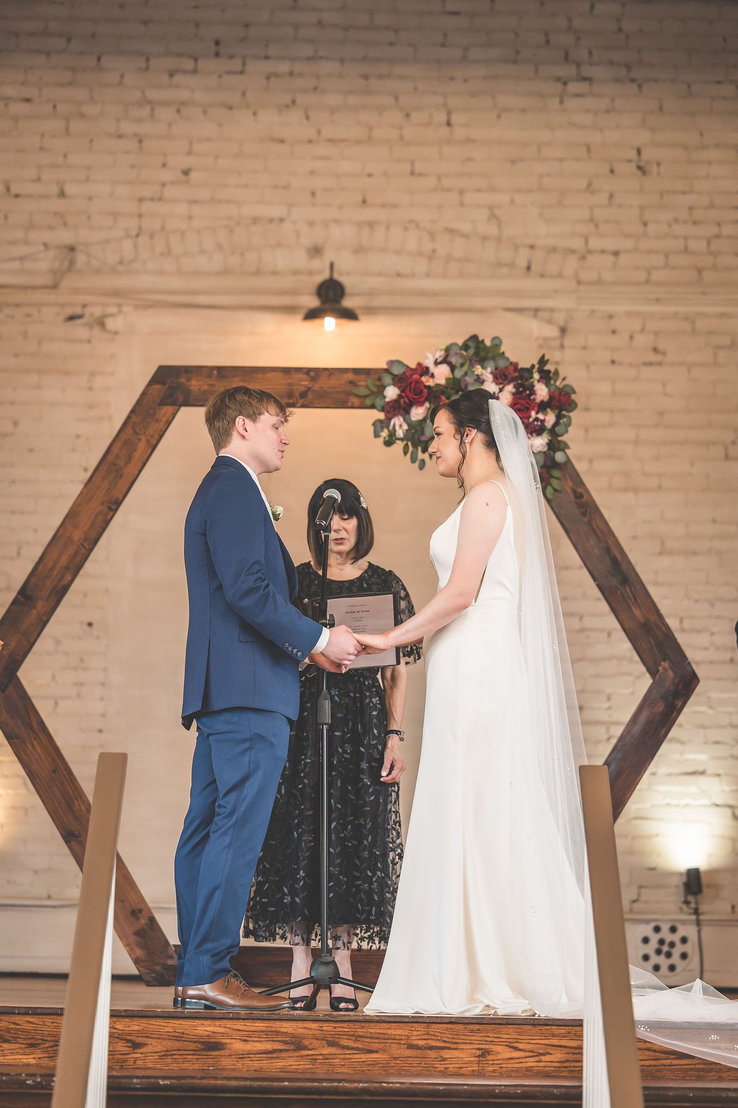 Wedding ceremony sequence showing intimate moments against exposed brick walls and wooden beams.