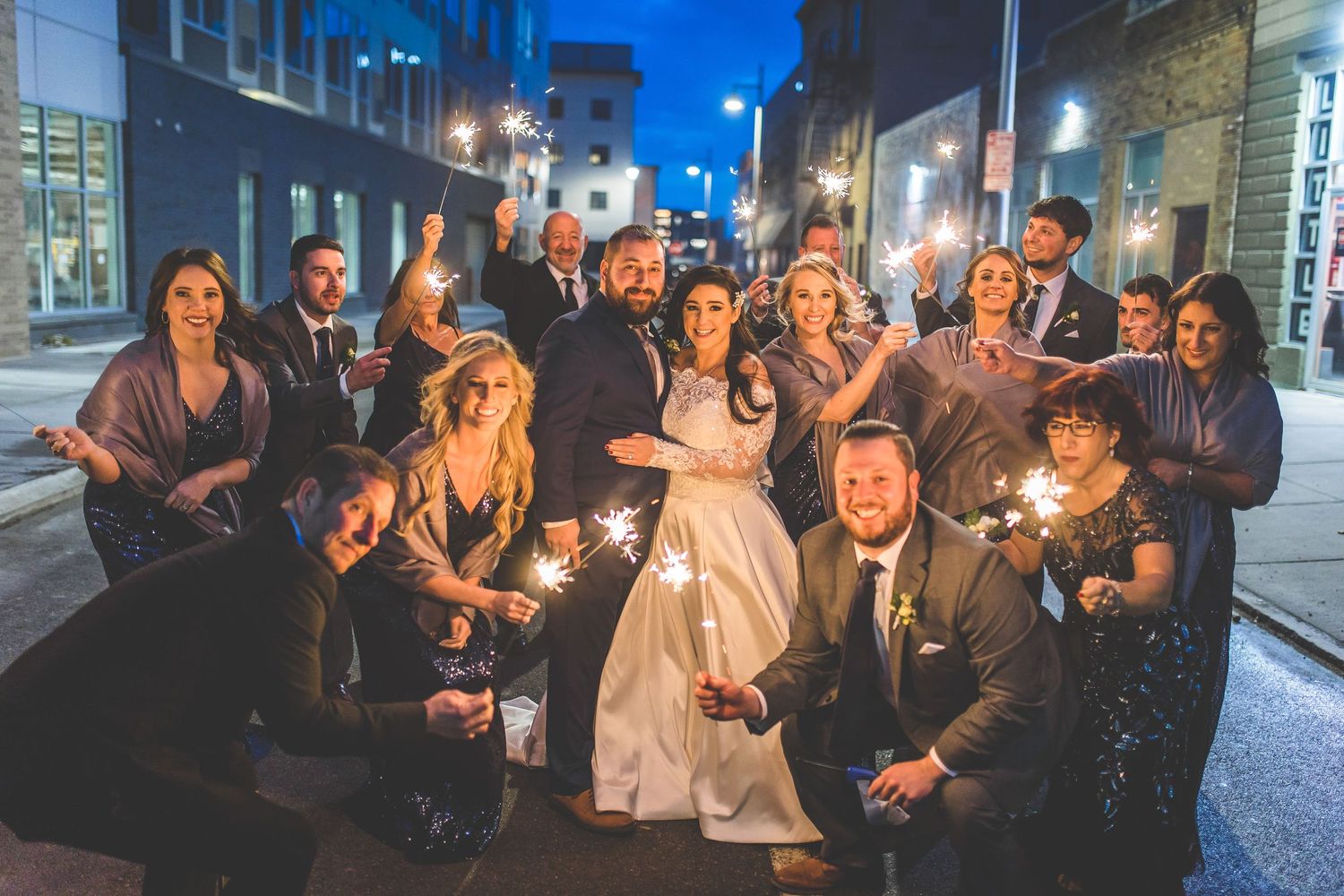 Wedding celebration at night with sparklers creating a magical atmosphere.