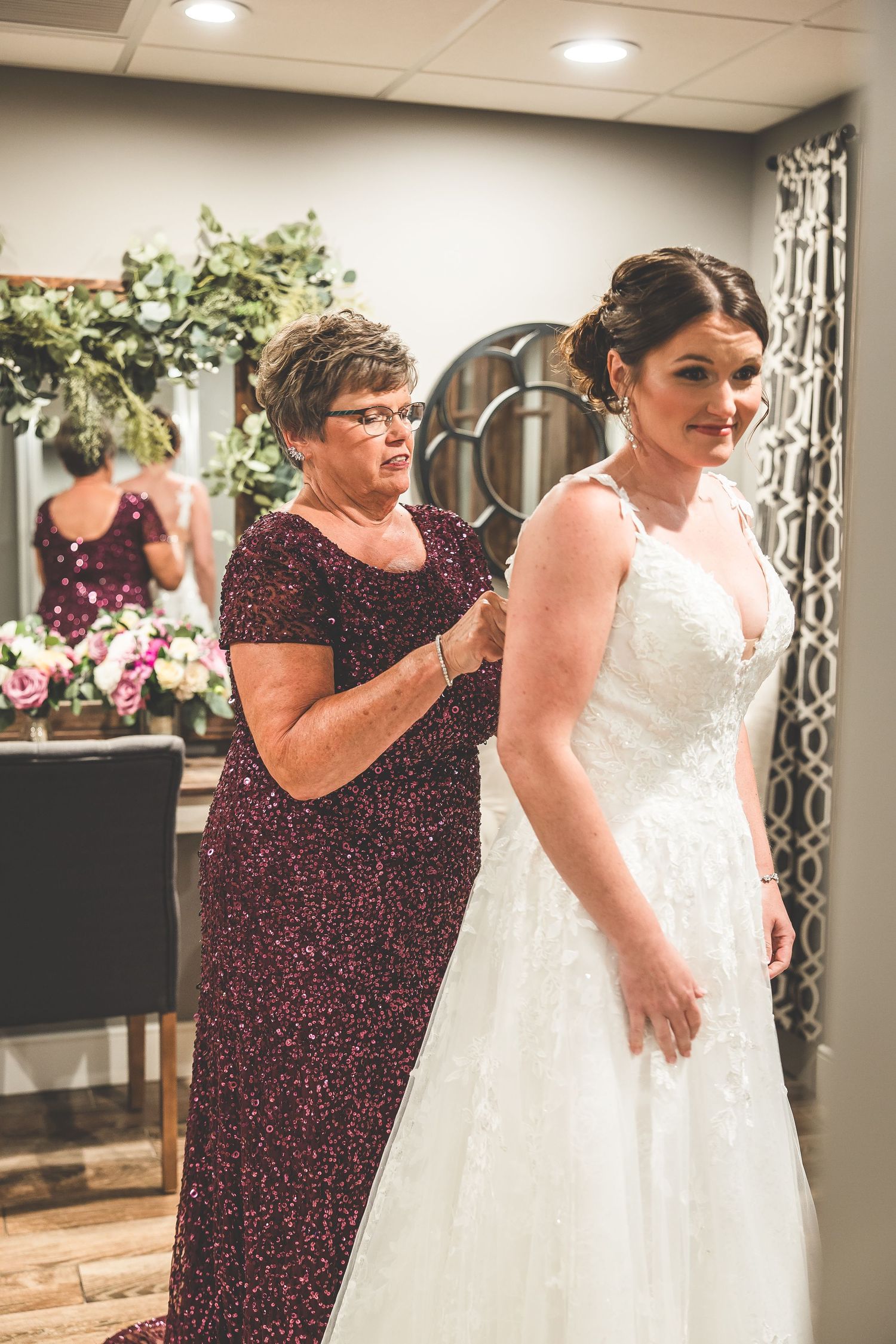 Final wedding dress adjustments being made during bridal preparation.