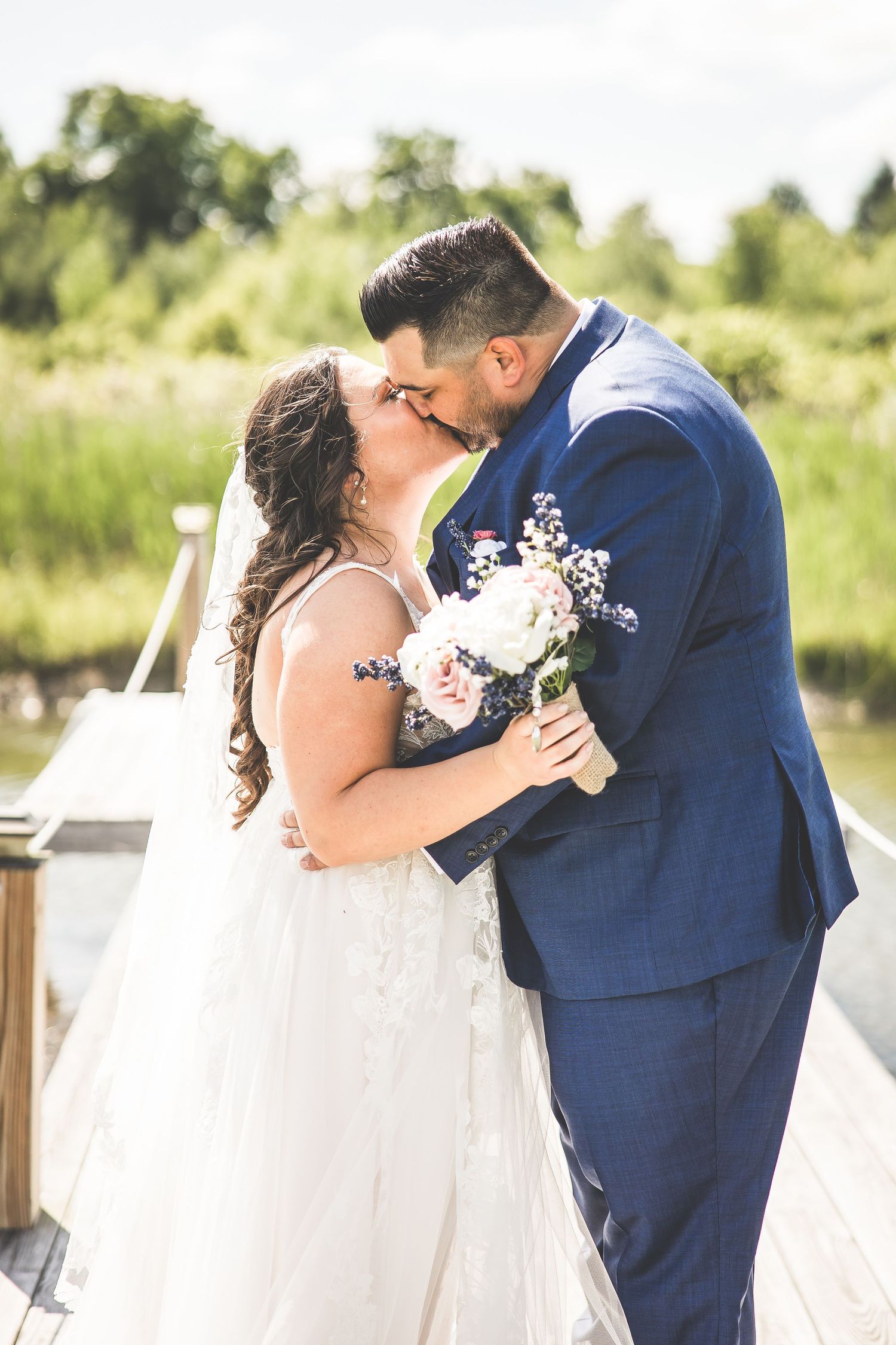 Series of intimate wedding photos captured on a wooden deck overlooking nature.