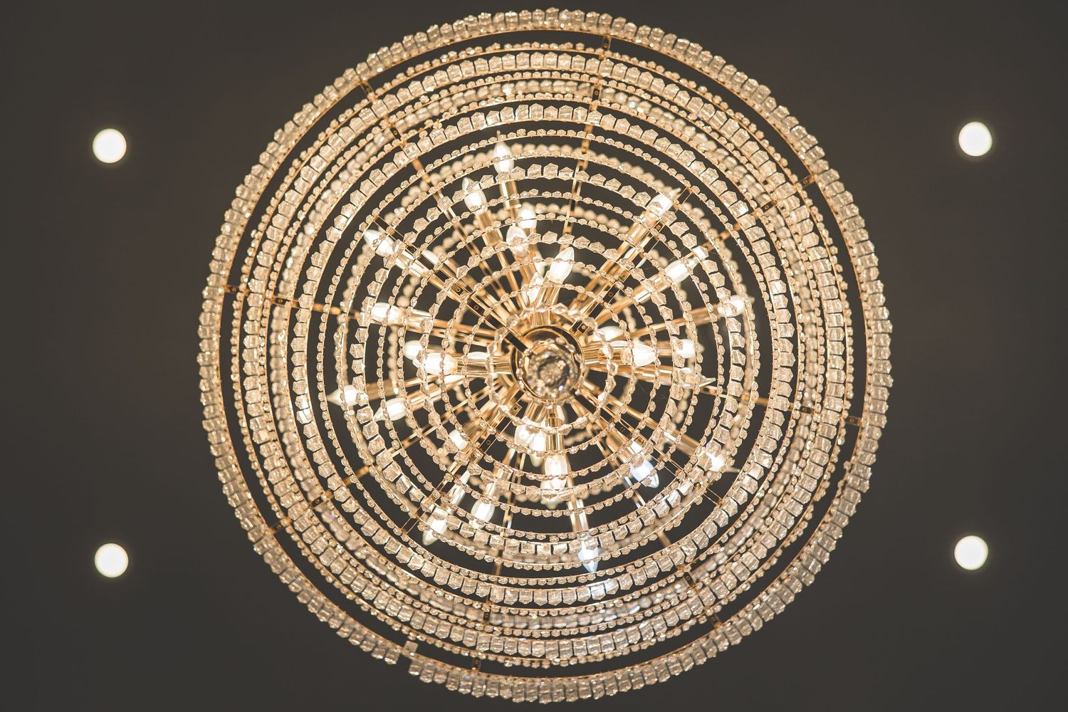 Close-up view of an ornate crystal chandelier with circular design.