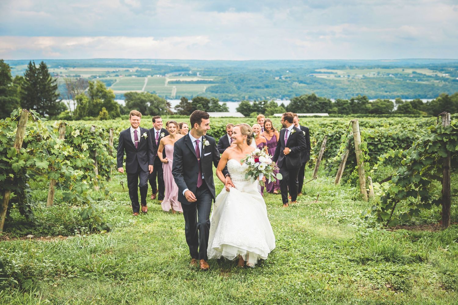 Wedding ceremony and group photos in a scenic vineyard setting.