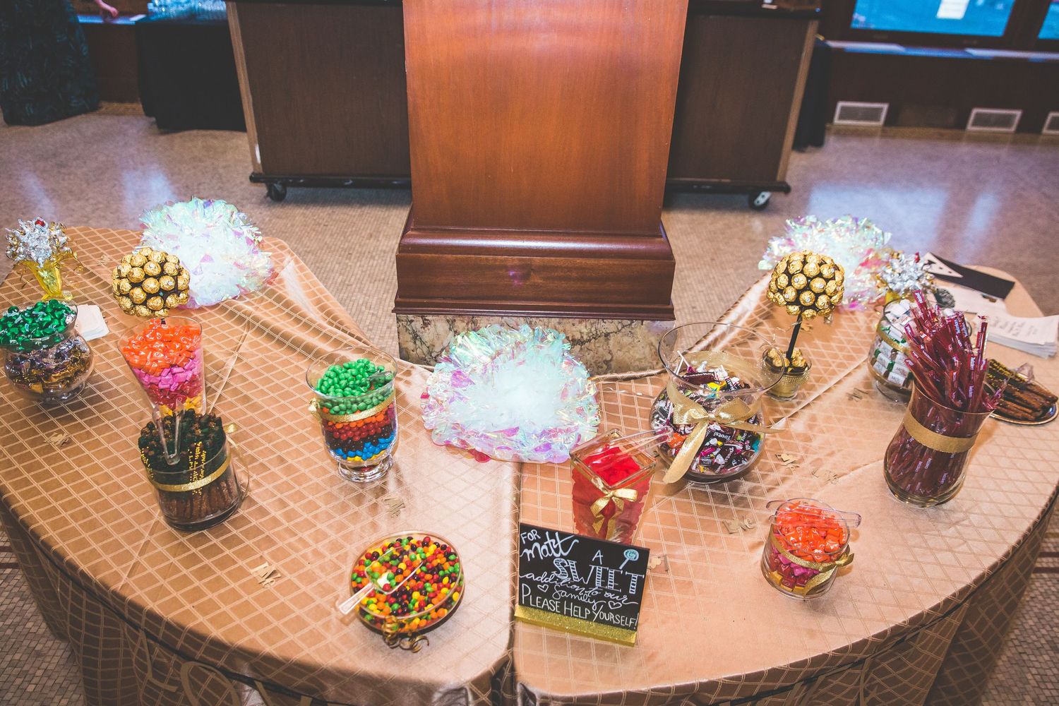 Decorative succulent centerpieces and table settings arranged on a textured surface at an event.