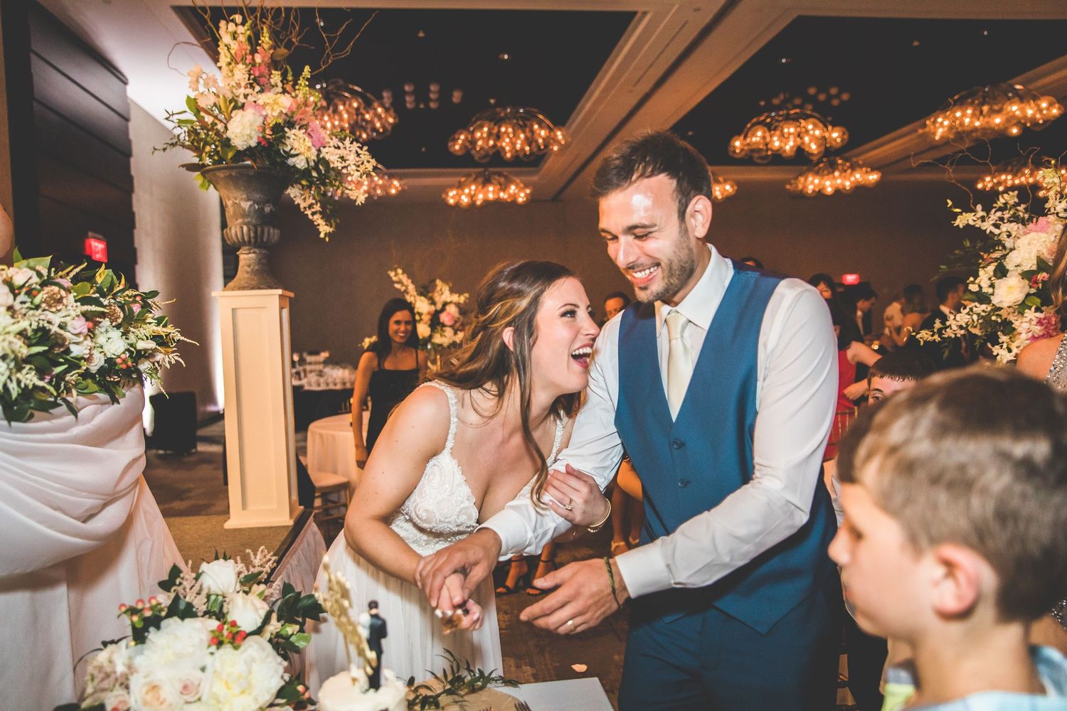 Wedding reception candid moments captured during evening celebrations with ambient lighting.