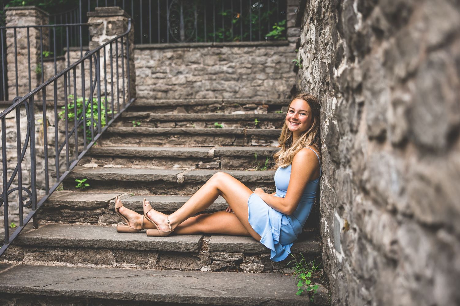 Stone staircase and wall creates dramatic backdrop for romantic summer photoshoot.